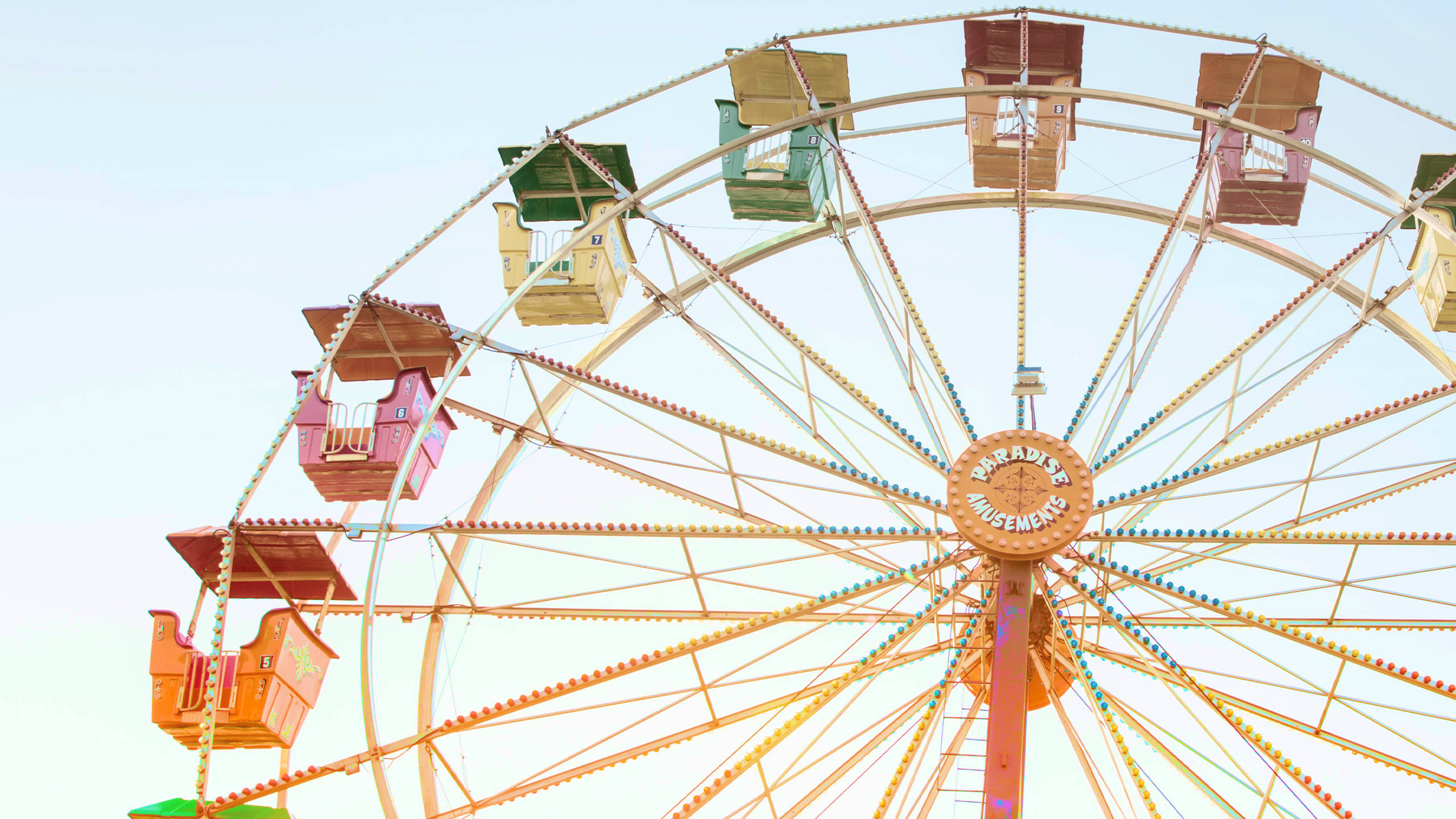 Ferris wheel, pastel cabins, soft blue sky, 2K Desktop Wallpaper