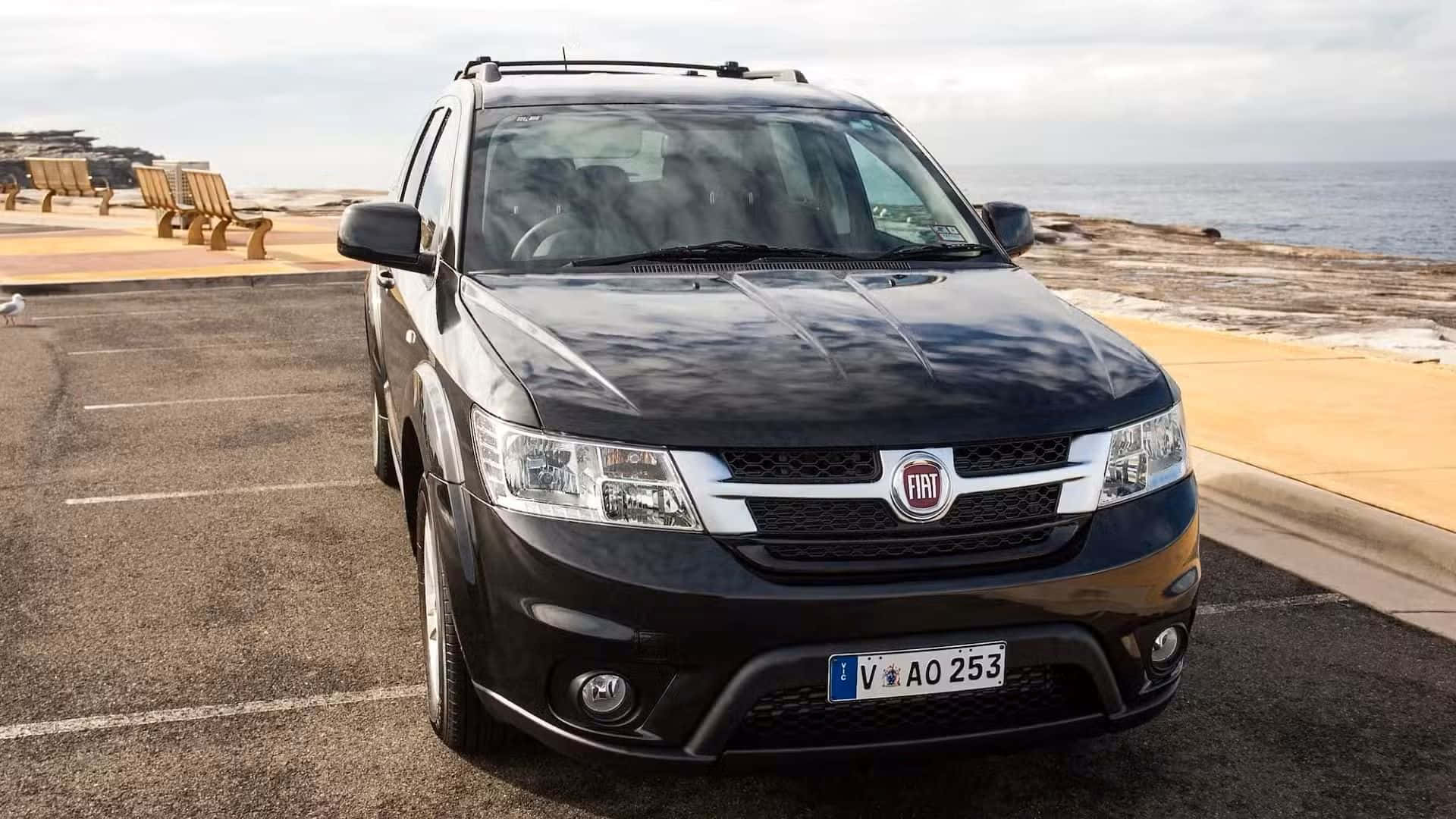 black Fiat Freemont, seaside parking lot, wooden beach chairs, Full HD Desktop Wallpaper