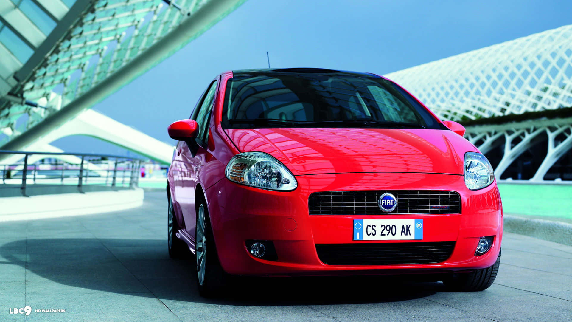 Fiat Grande Punto, vibrant red, modern glass and steel architectural structure, Full HD Desktop Wallpaper