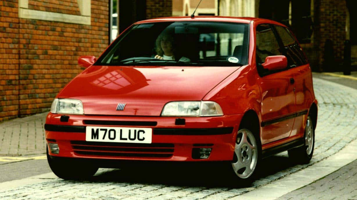 Fiat Punto, vibrant red, cobblestone street, SD Desktop Wallpaper