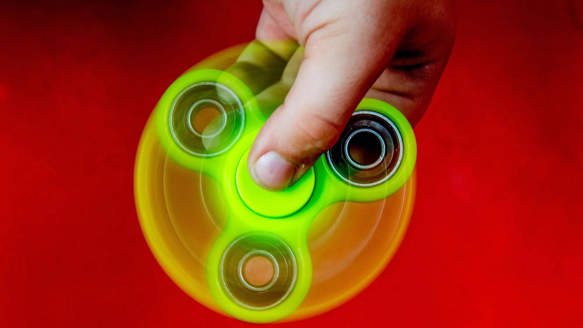 neon green fidget spinner, vivid red background, hand grips, Full HD Desktop Wallpaper