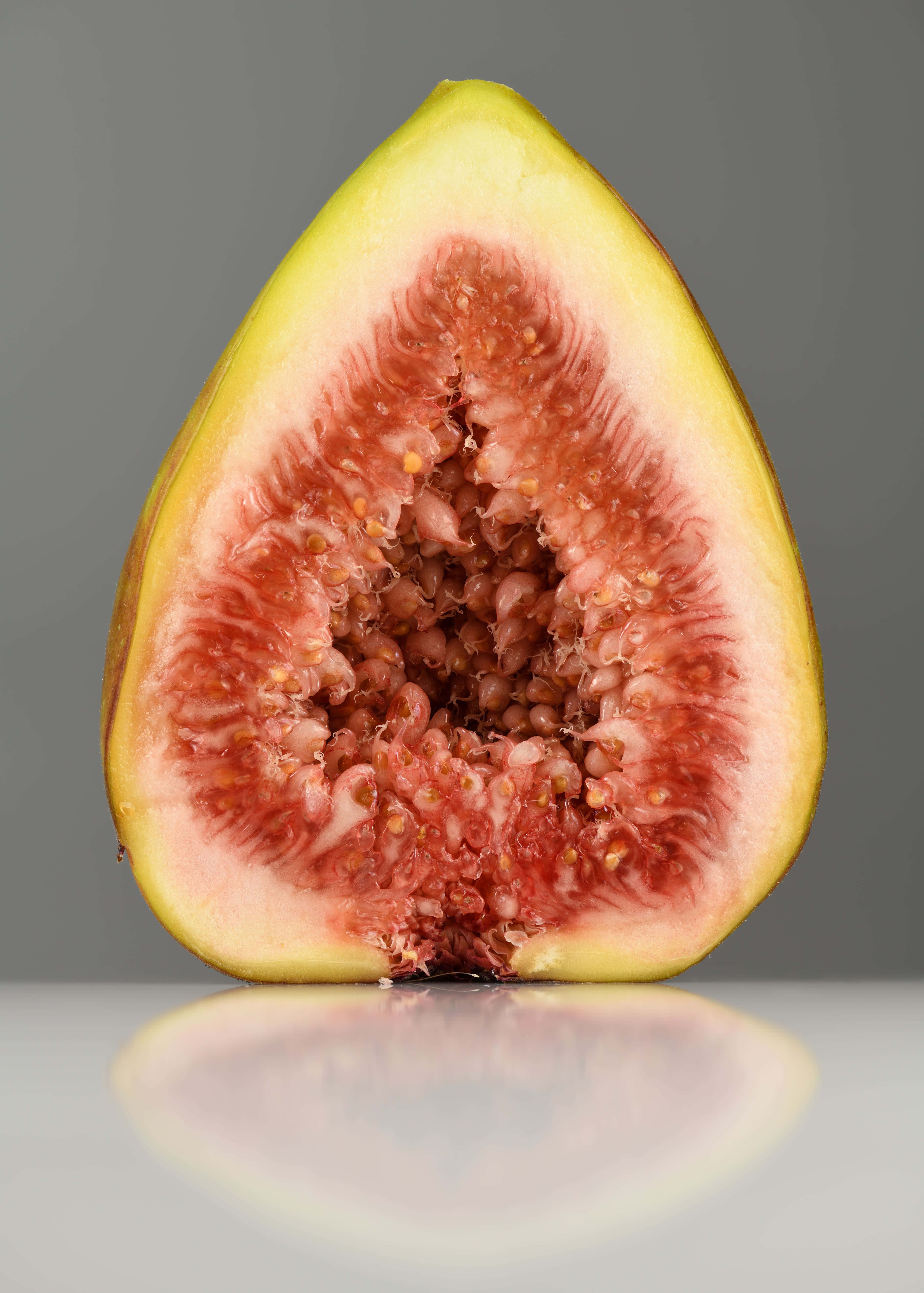 fresh fig half cut, juicy pink flesh, tiny seeds, 8K Phone Wallpaper