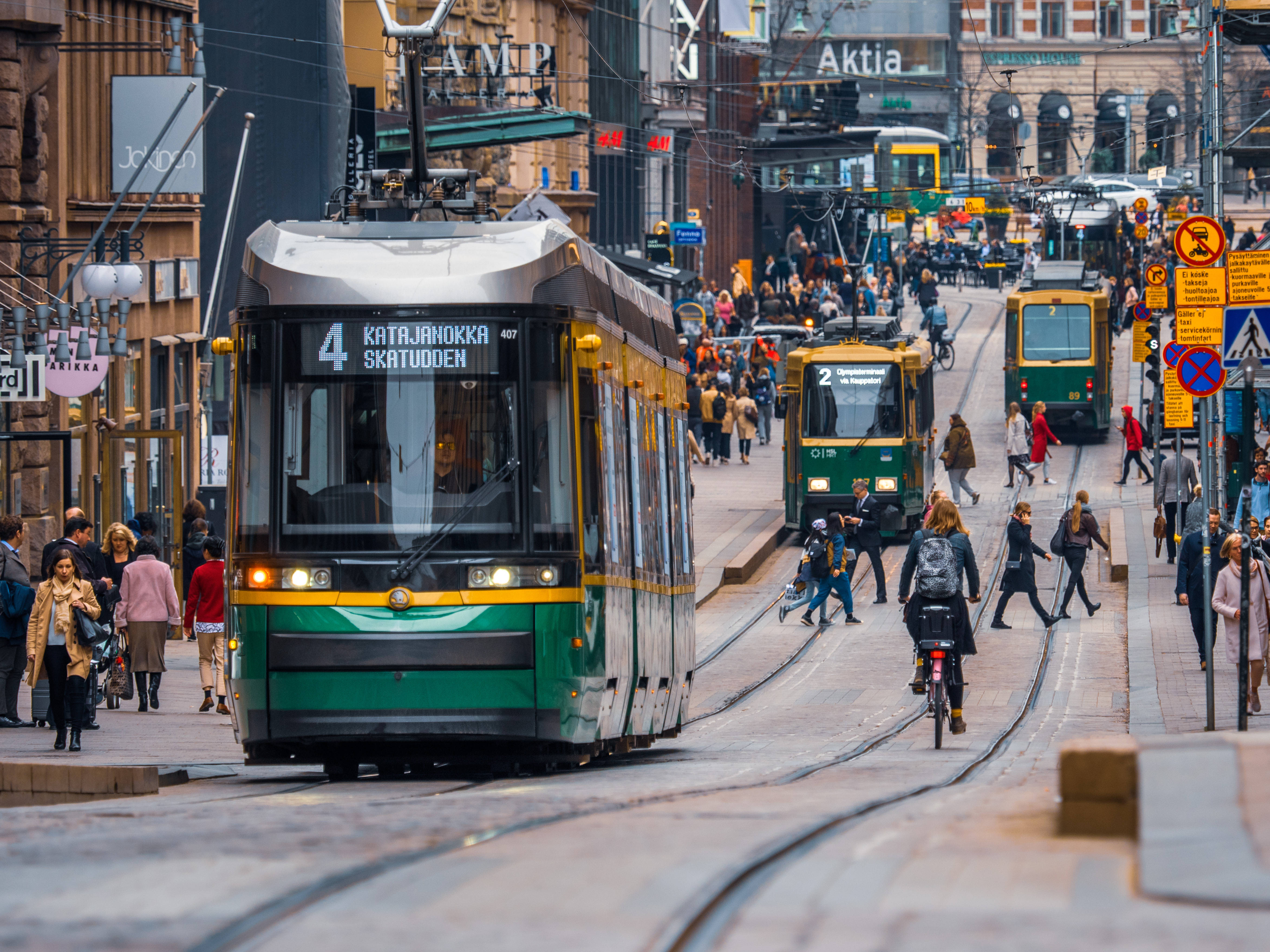 Finland, green and yellow tram, bustling city street, 4K Desktop Wallpaper