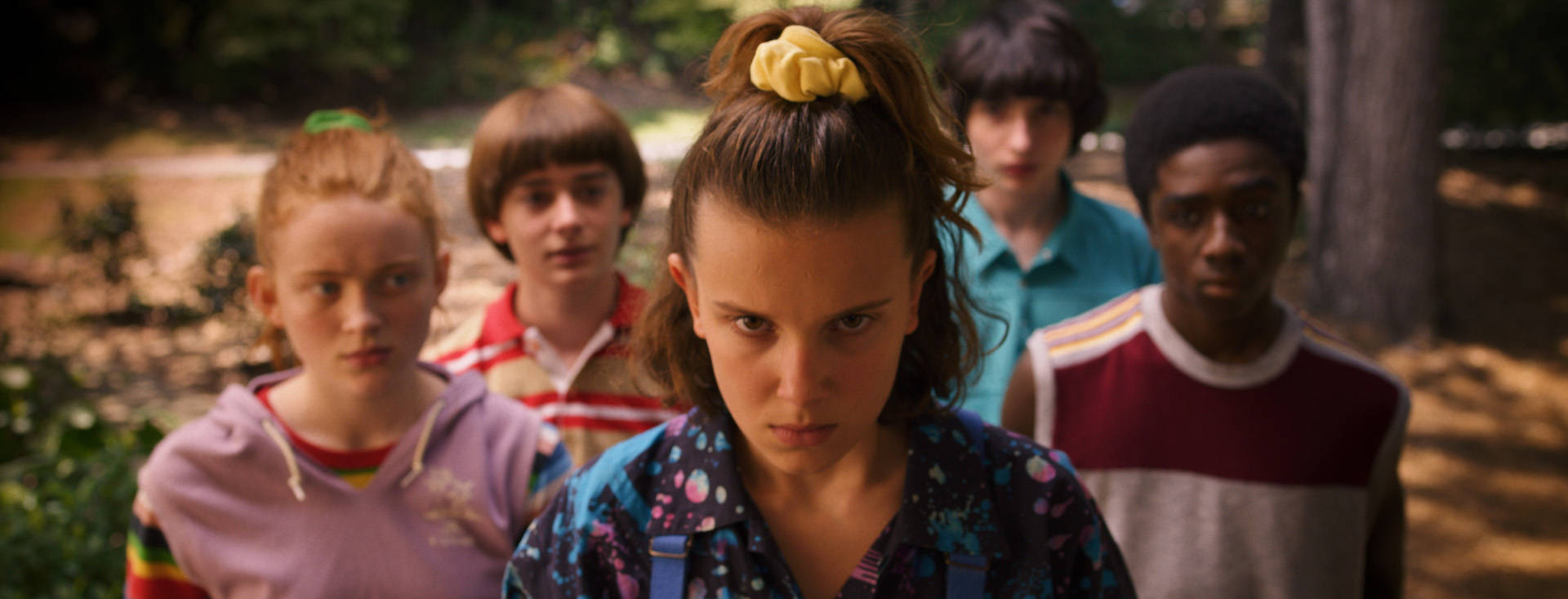 Finn Wolfhard, sunlit forest clearing, yellow scrunchie, Full HD Desktop Wallpaper
