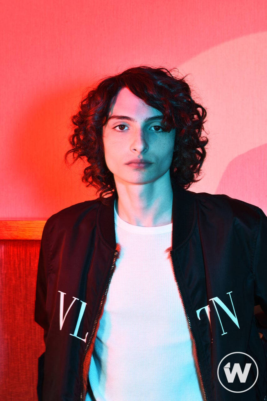 Finn Wolfhard, black bomber jacket, red and blue neon lighting, HD Phone Wallpaper