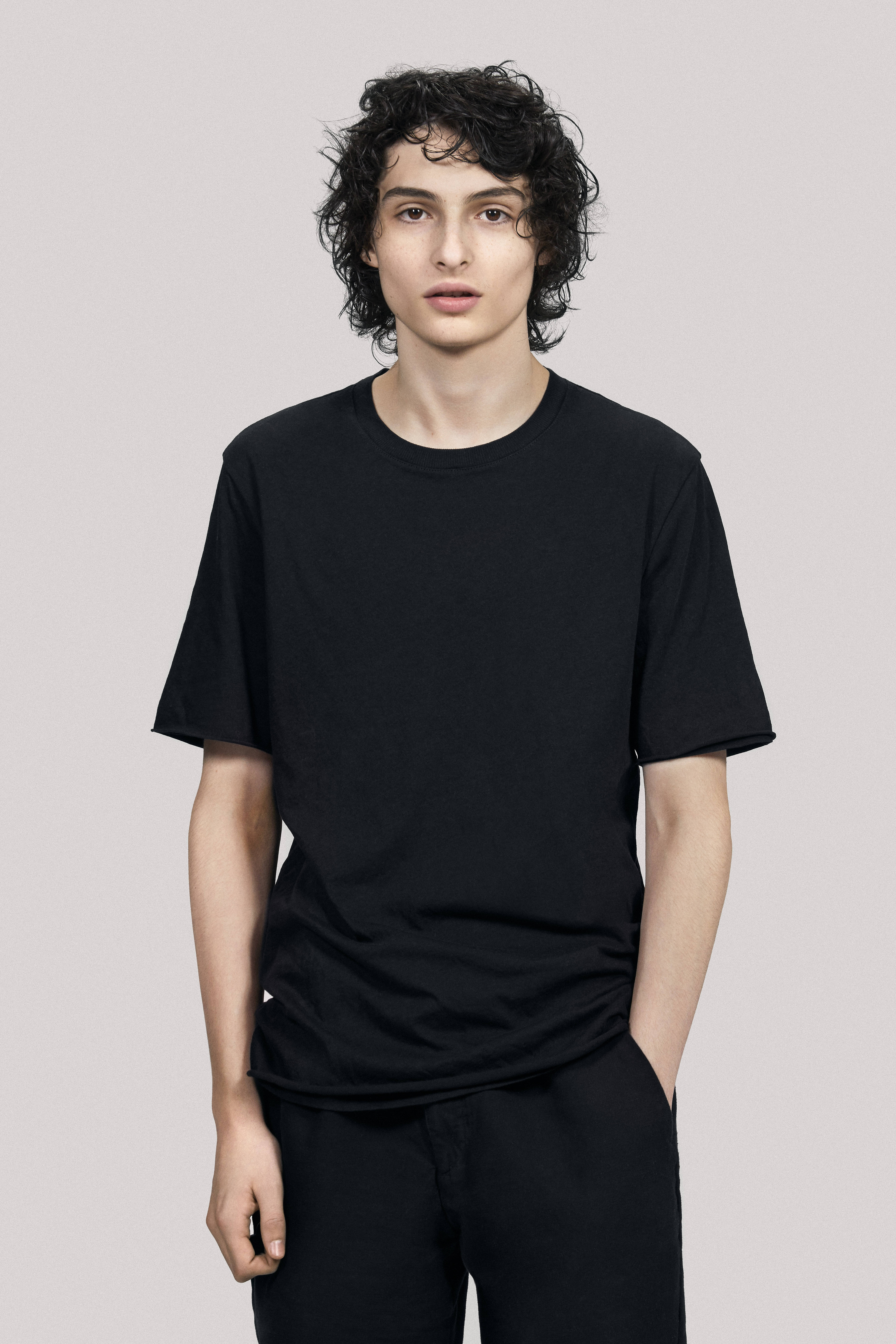 Finn Wolfhard, black t-shirt, black pants, 8K Phone Wallpaper
