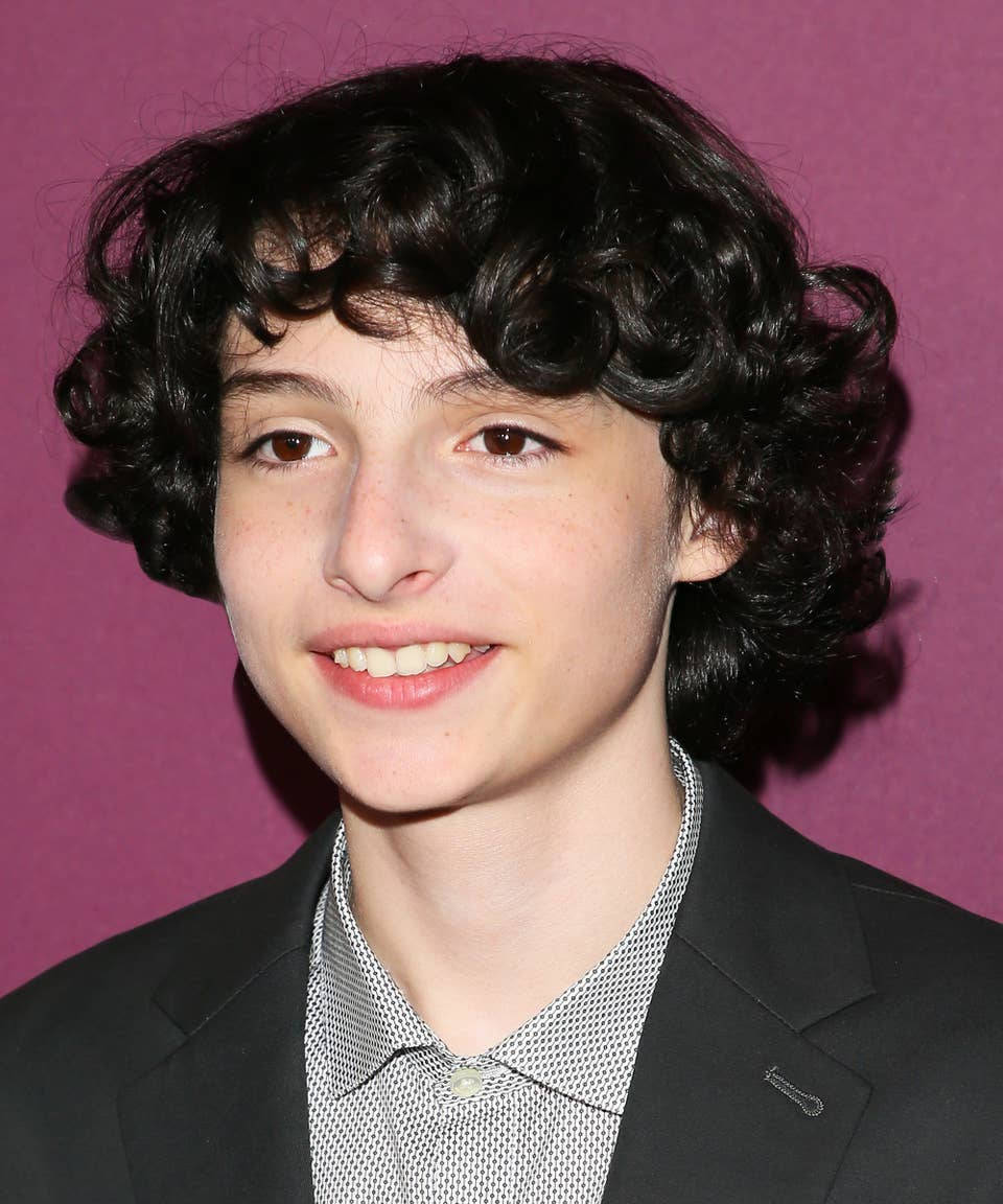 Finn Wolfhard, curly dark hair, solid purple background, SD Phone Wallpaper