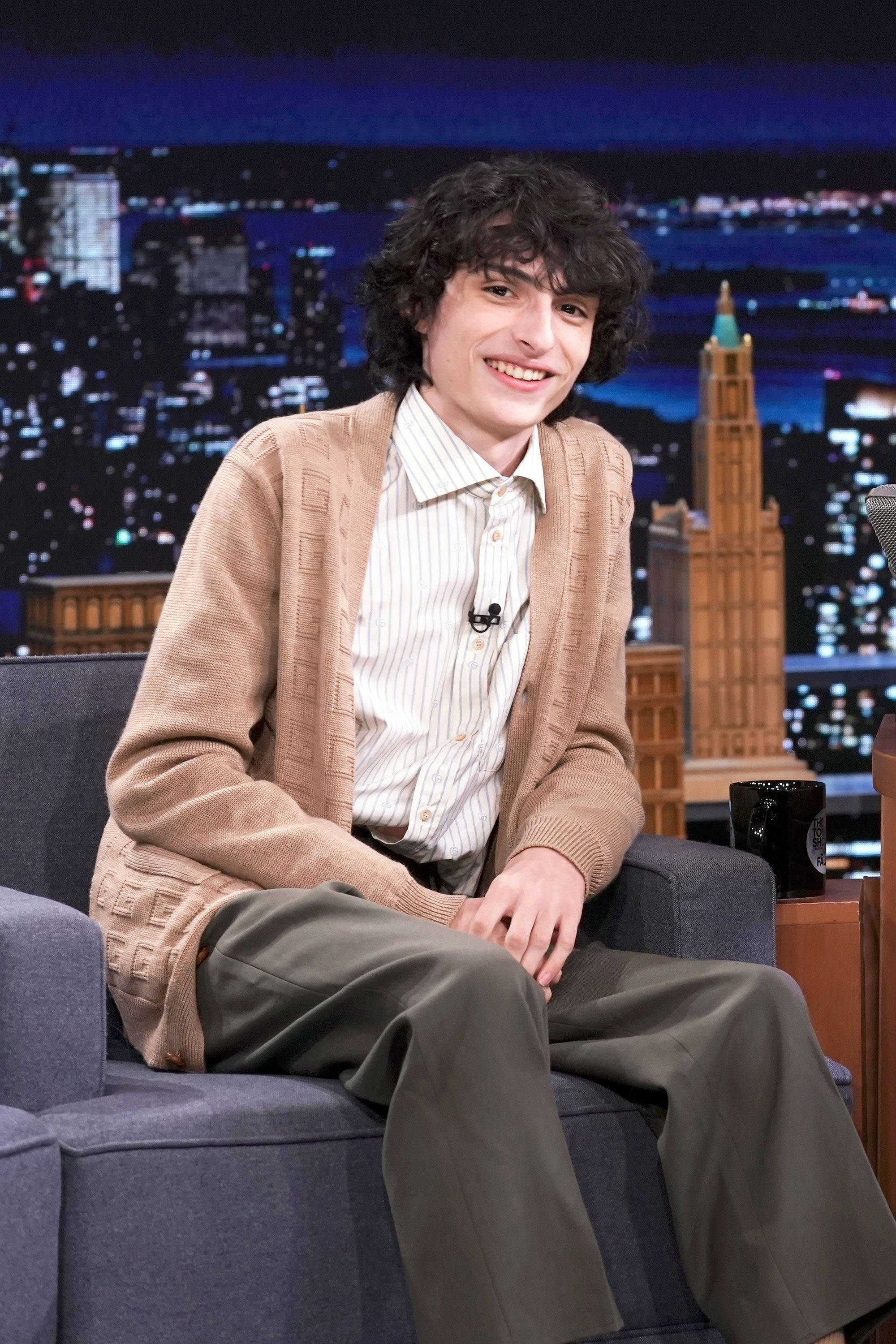Finn Wolfhard, talk show set, blue armchair, 2K Phone Wallpaper