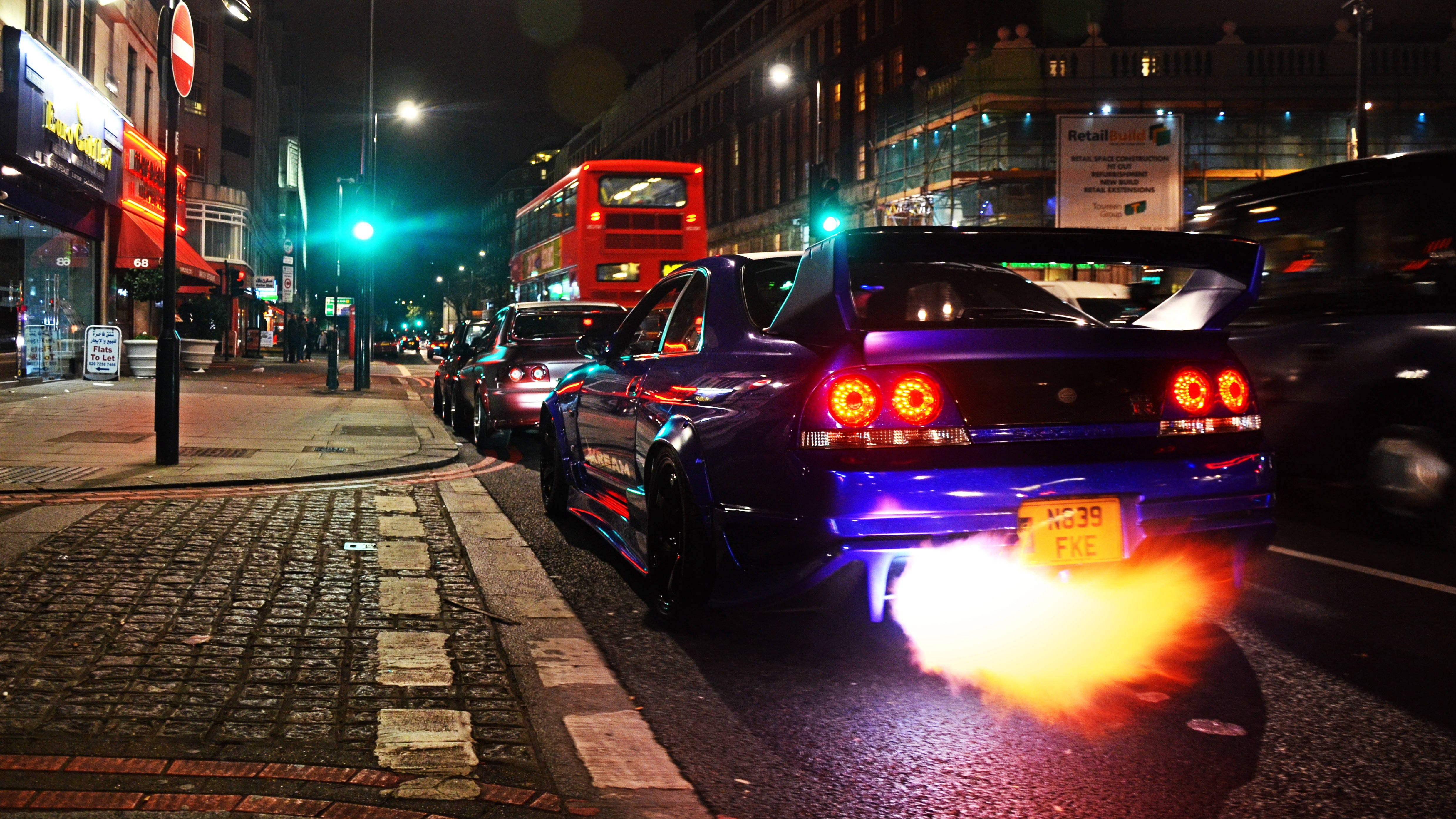 vibrant purple sports car, glowing orange exhaust flames, wet city street, 4K Desktop Wallpaper