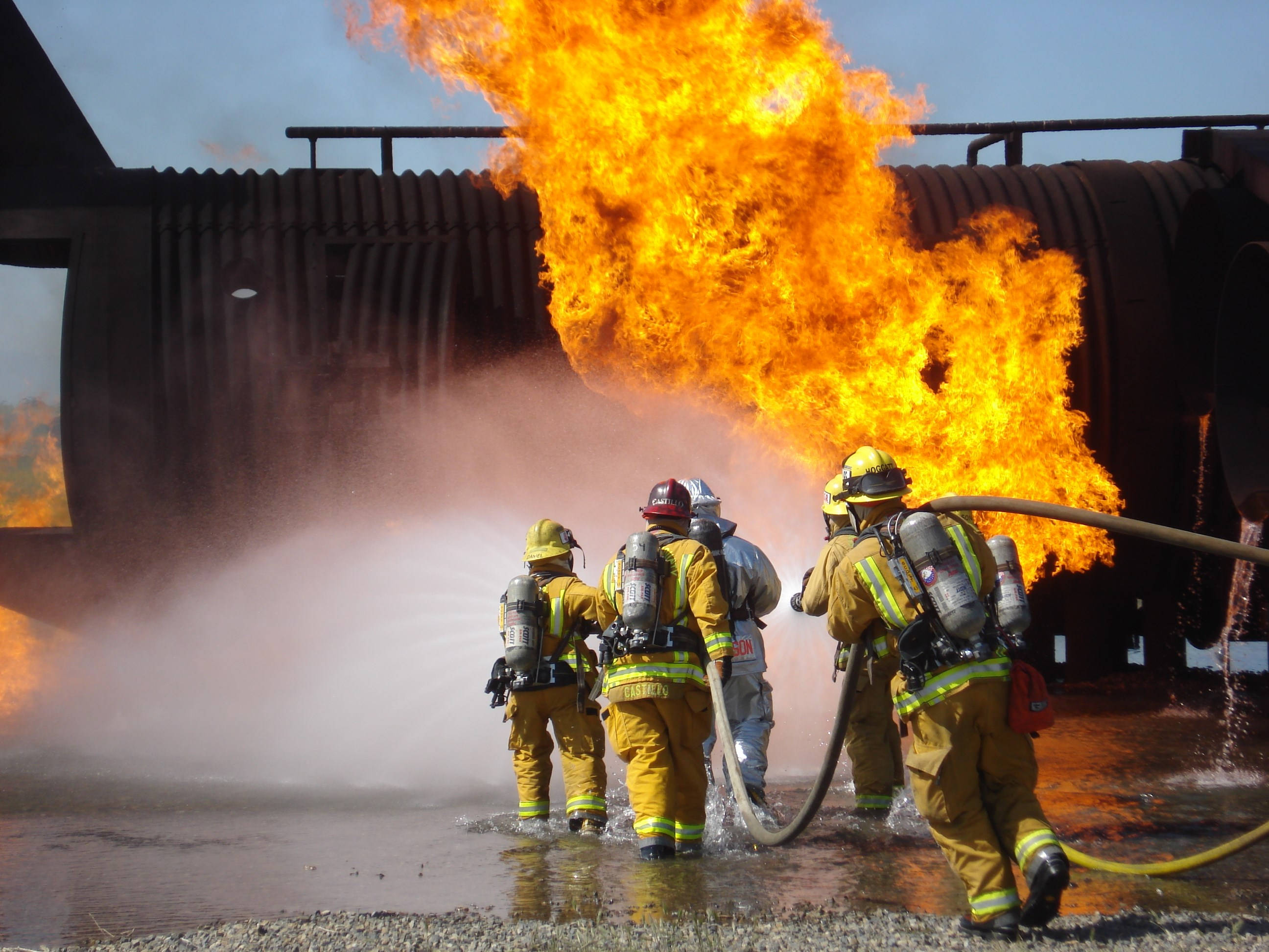 Firefighters, full gear, roaring orange flame, 2K Desktop Wallpaper