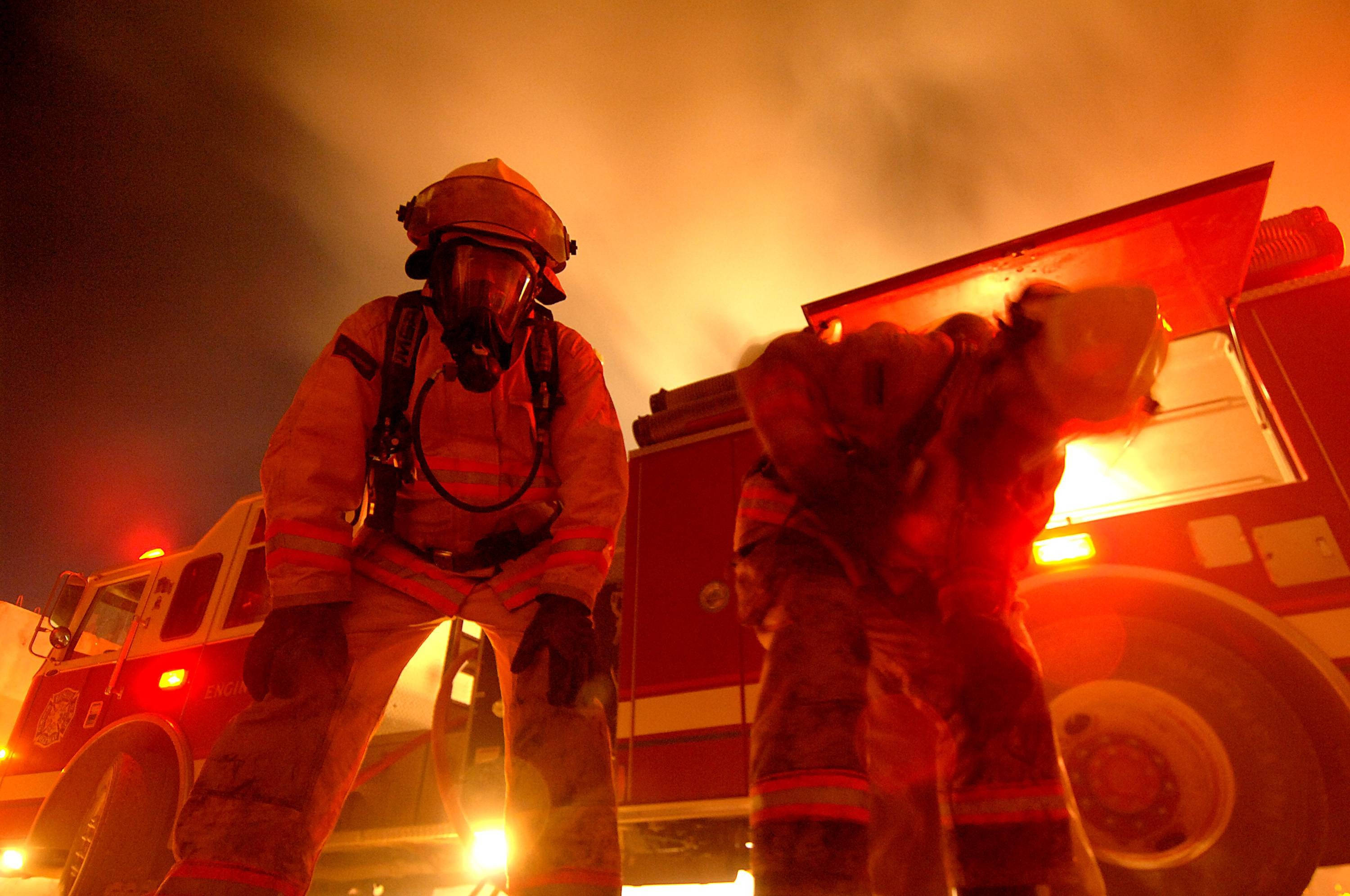 Fireman, full gear, fiery orange glow, 2K Desktop Wallpaper