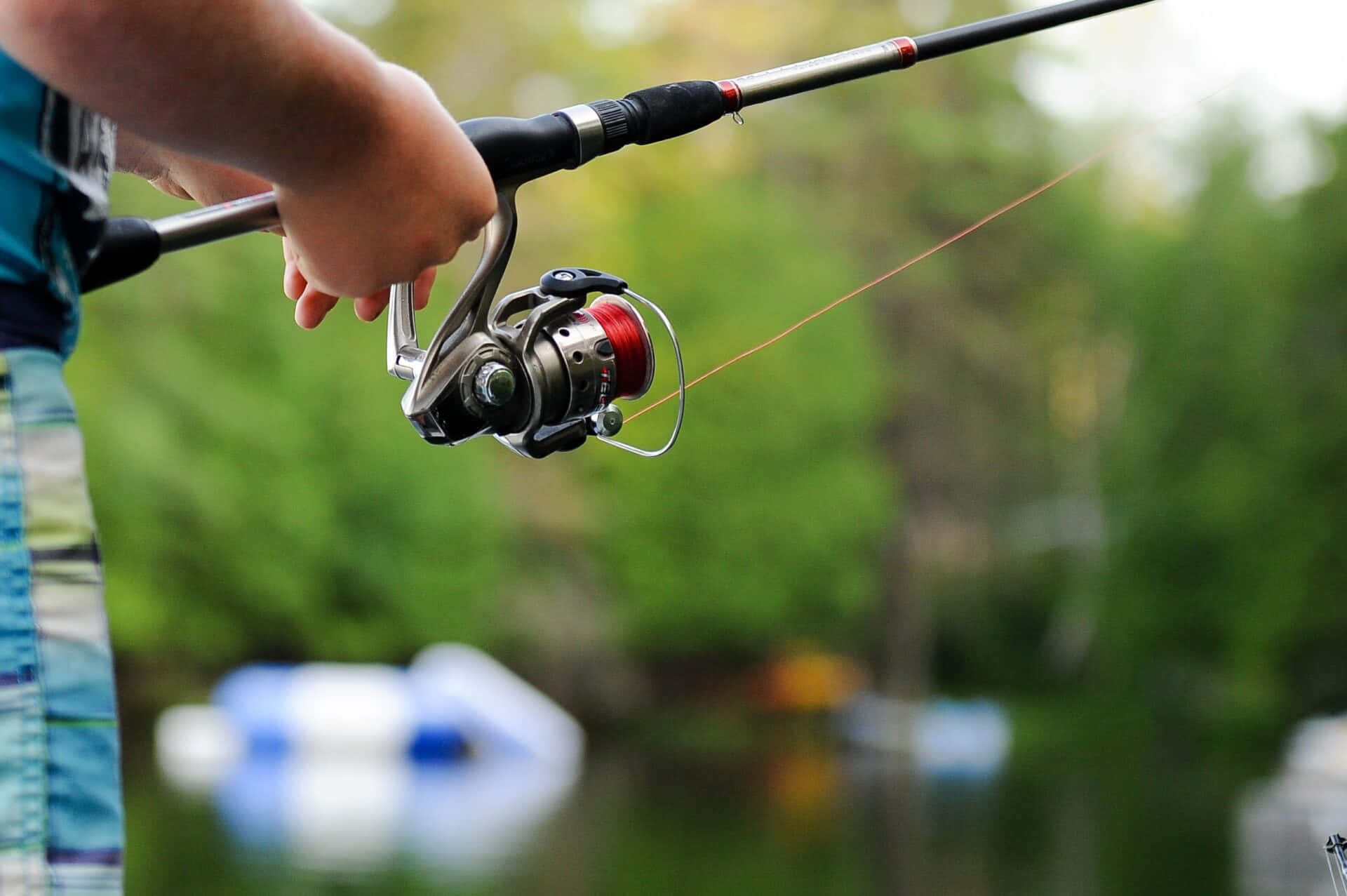 fishing rod, red spool reel, blurred green forest, Full HD Desktop Wallpaper