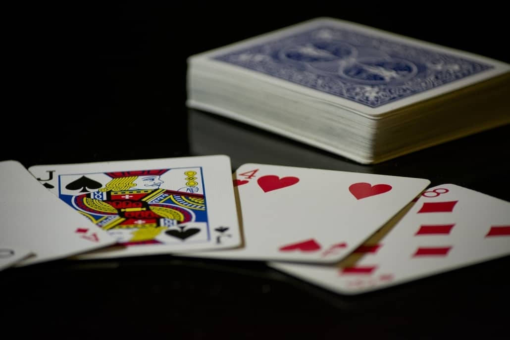 Five-card Draw, blue-backed playing cards, glossy black surface, SD Desktop Wallpaper