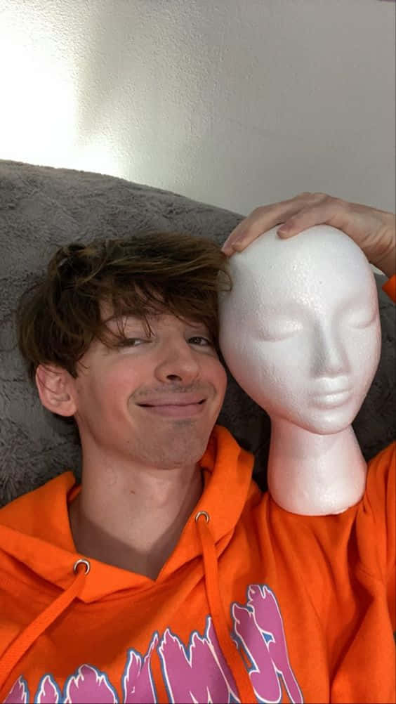 Flamingo Albert, orange hoodie, white mannequin head, SD Phone Wallpaper