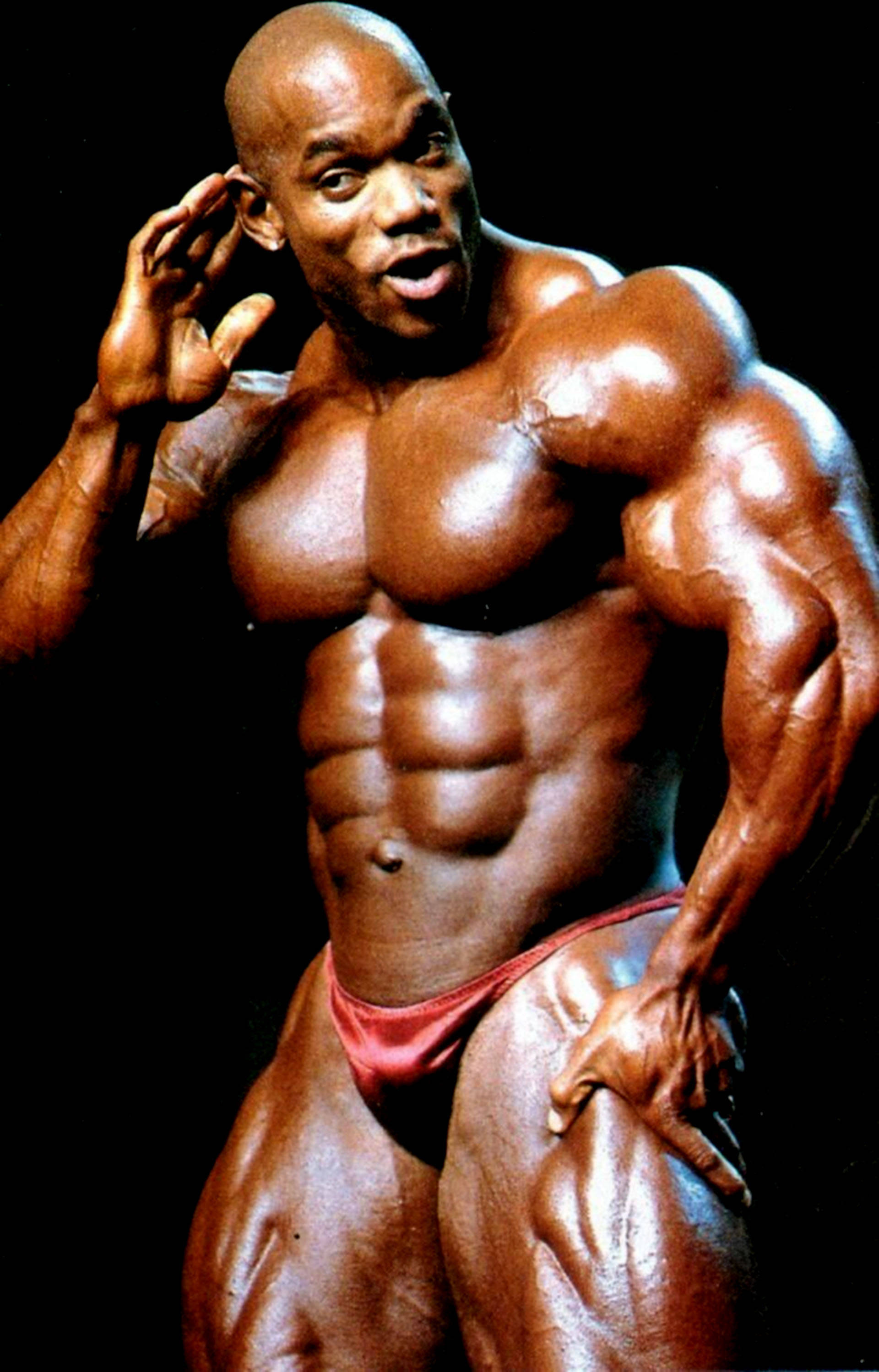 Flex Wheeler, red posing trunks, defined abs, 2K Phone Wallpaper