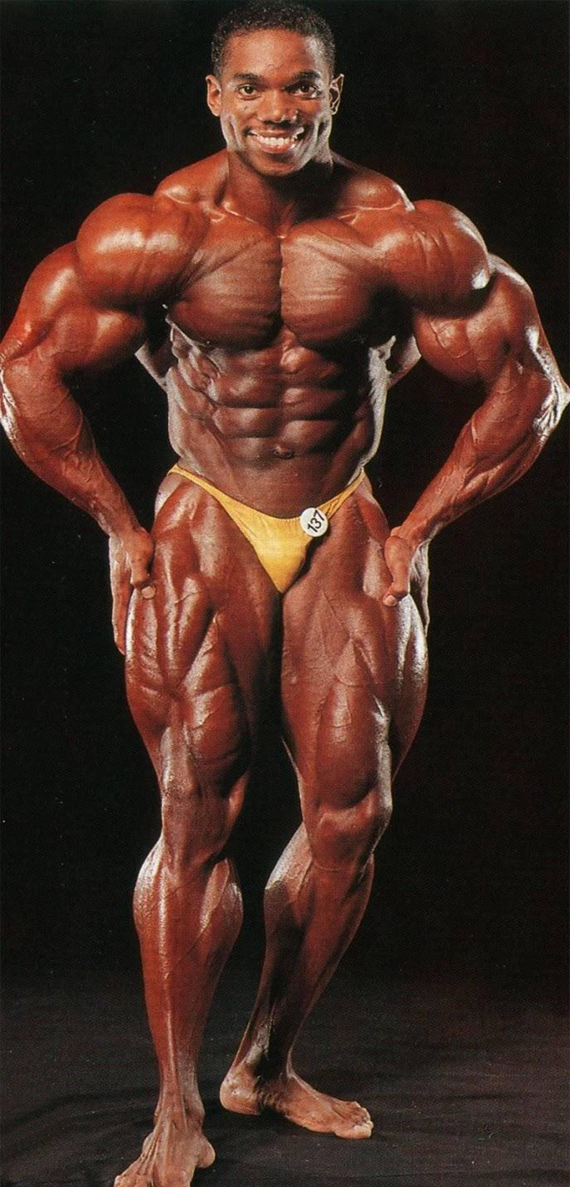 Flex Wheeler, yellow posing trunks, black background, 4K Phone Wallpaper