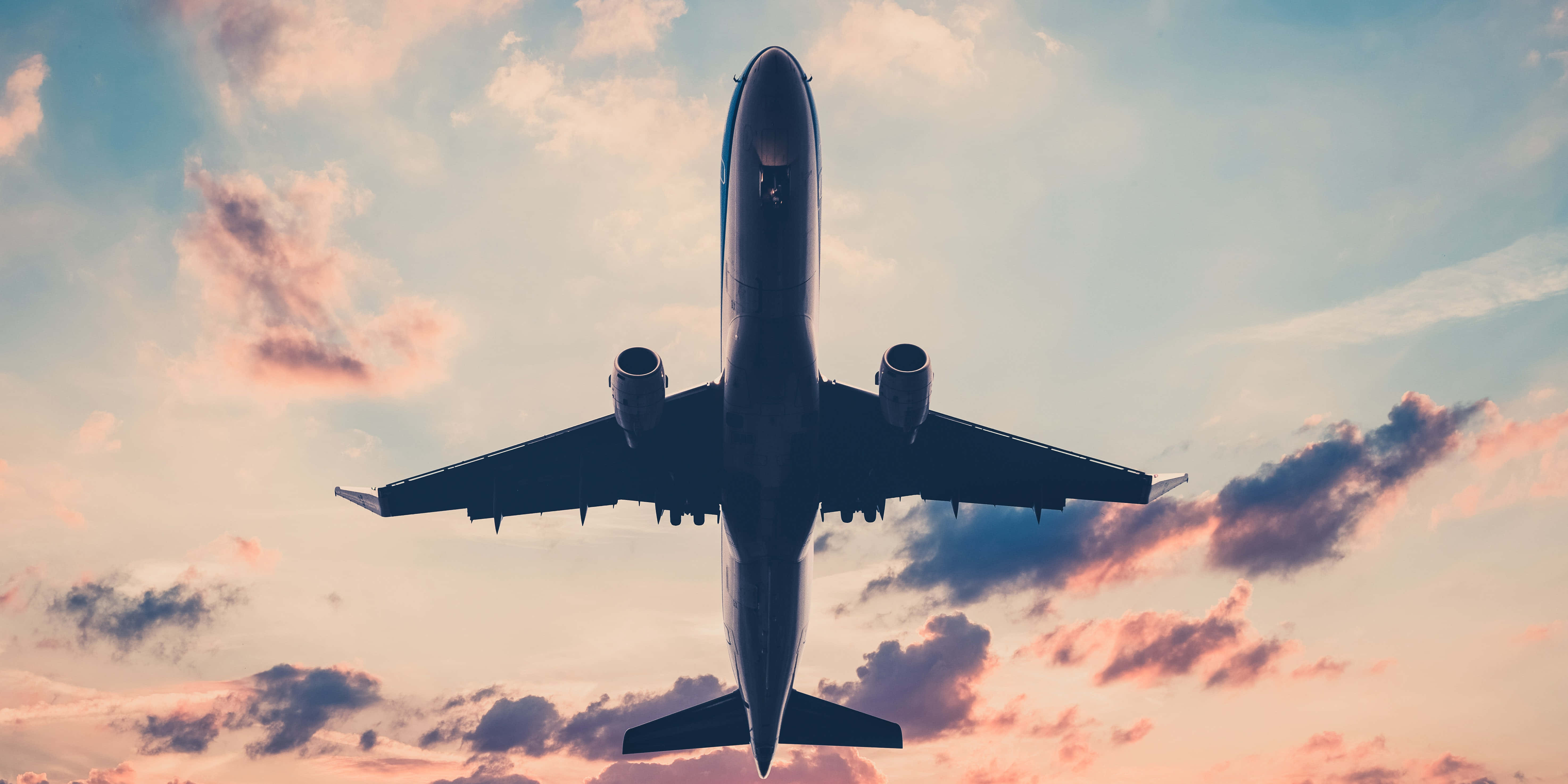 commercial airplane, vibrant sunset sky, pink and orange clouds, 5K Desktop Wallpaper