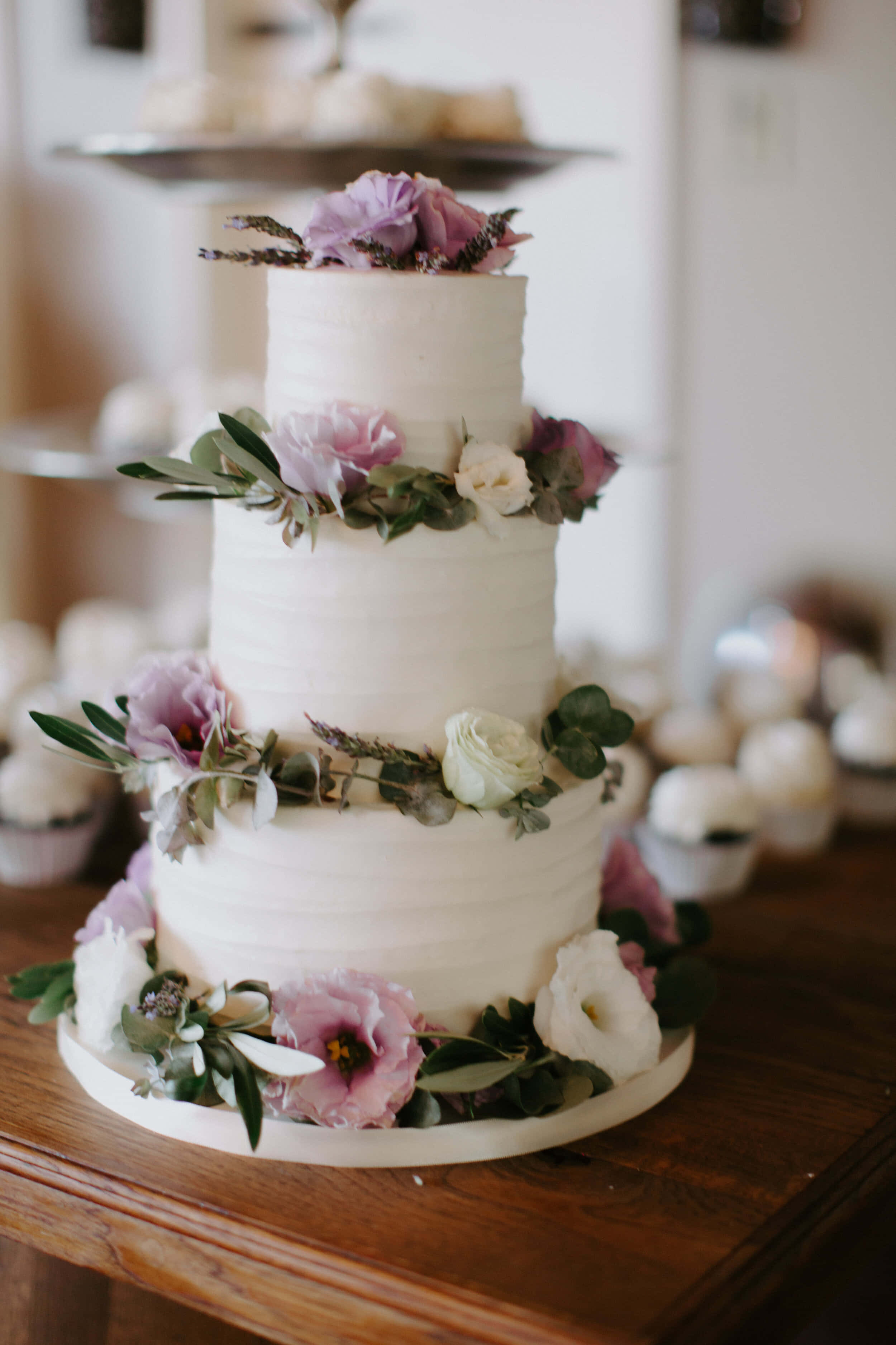 three-tiered white wedding cake, soft pink and white flowers, greenery, 2K Phone Wallpaper