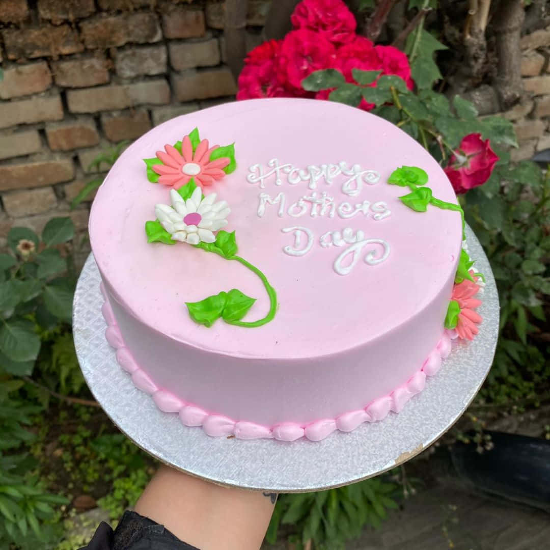 pink frosted cake, white cursive 'Happy Mothers Day', sugar flowers, SD Desktop Wallpaper