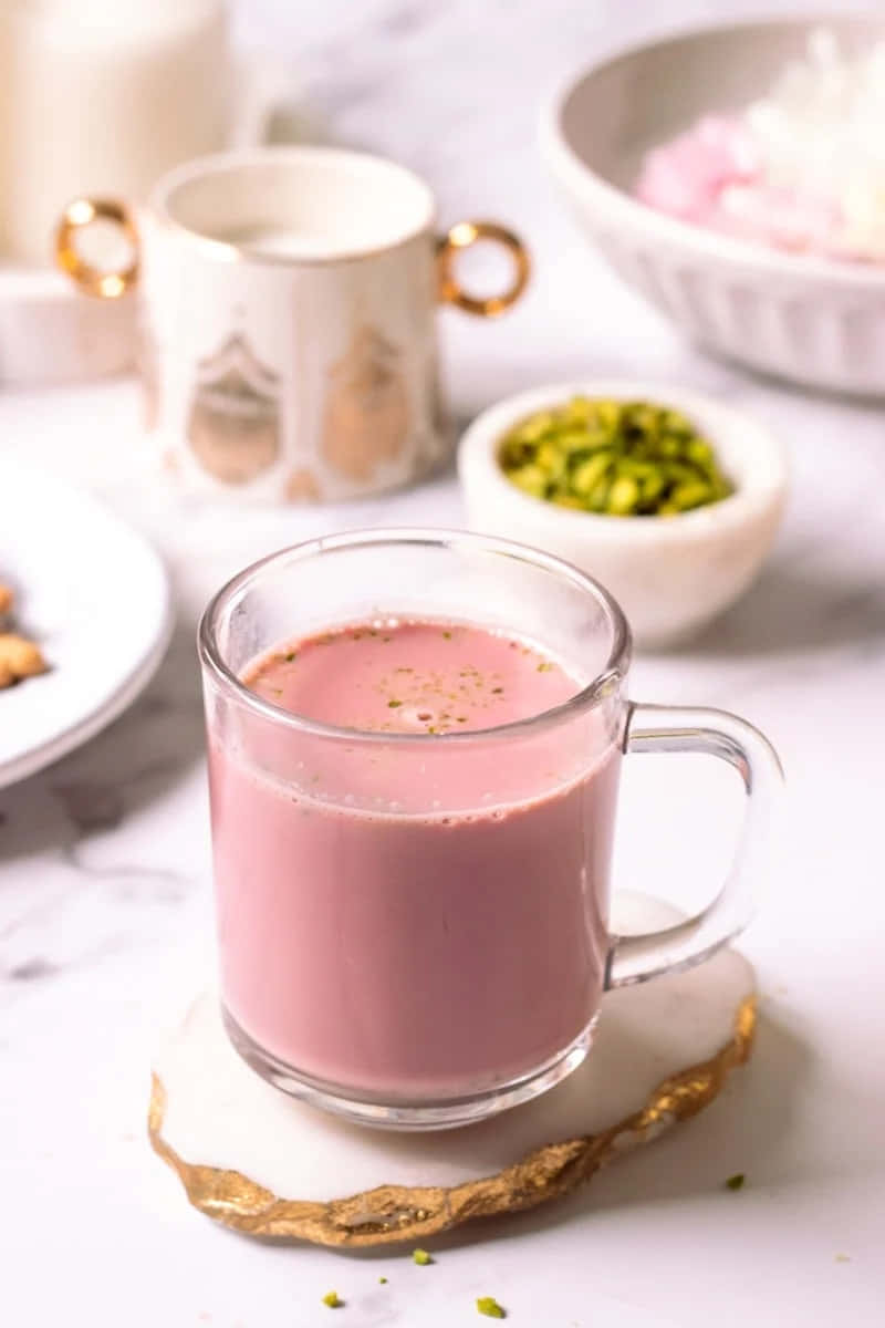 pink milk drink, pistachios, gold-rimmed coaster, SD Phone Wallpaper
