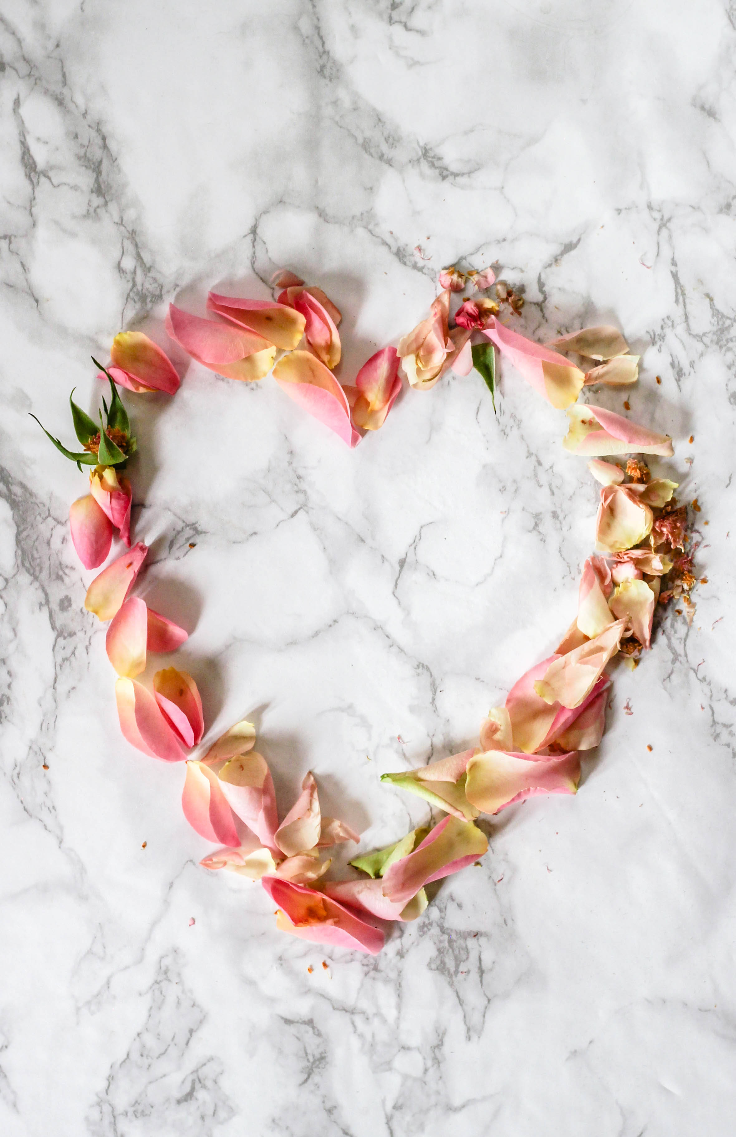 pink rose petals, heart shape, white marble surface, 2K Phone Wallpaper