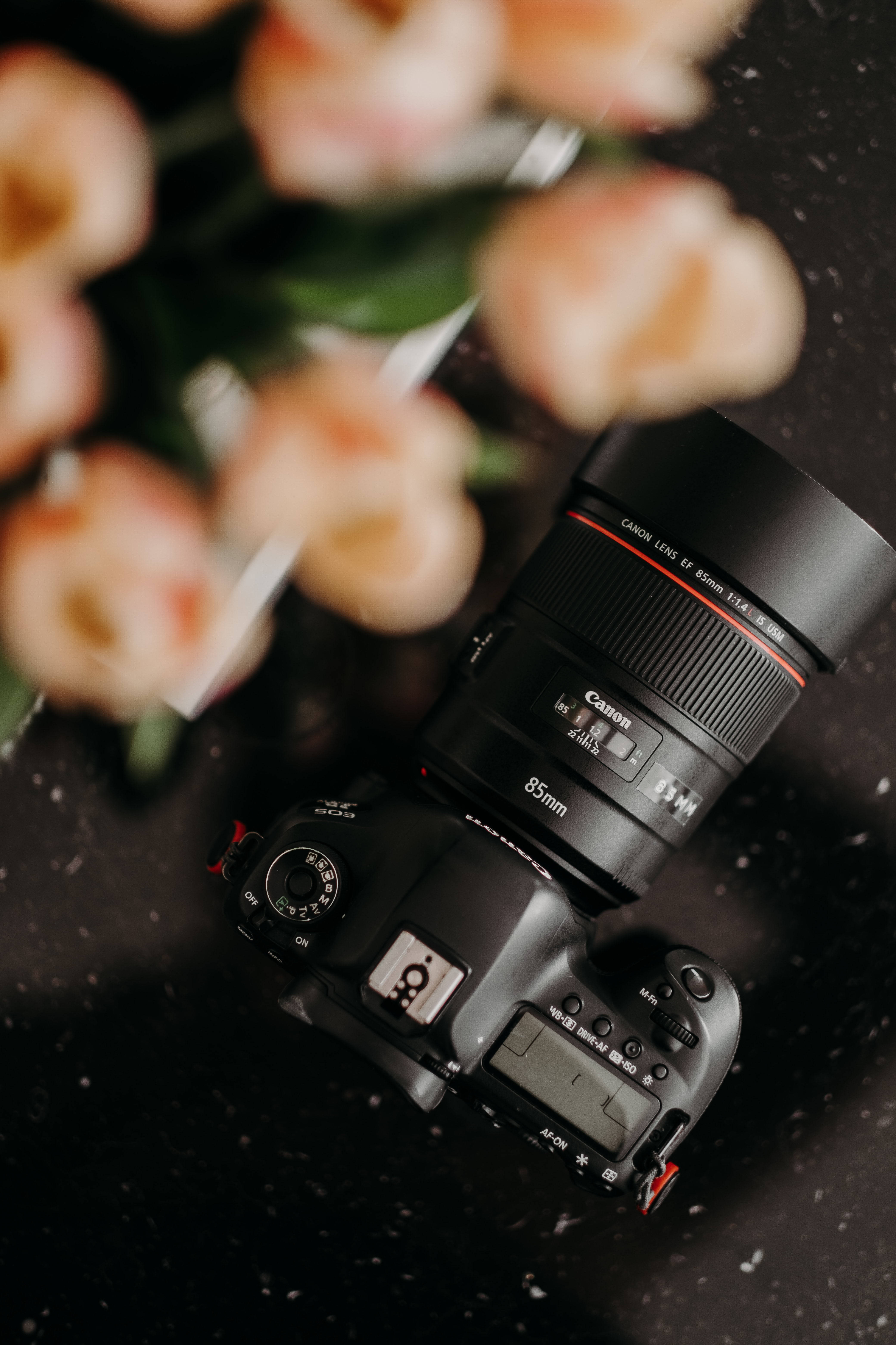Canon DSLR camera, 85mm lens, dark speckled surface, 5K Phone Wallpaper