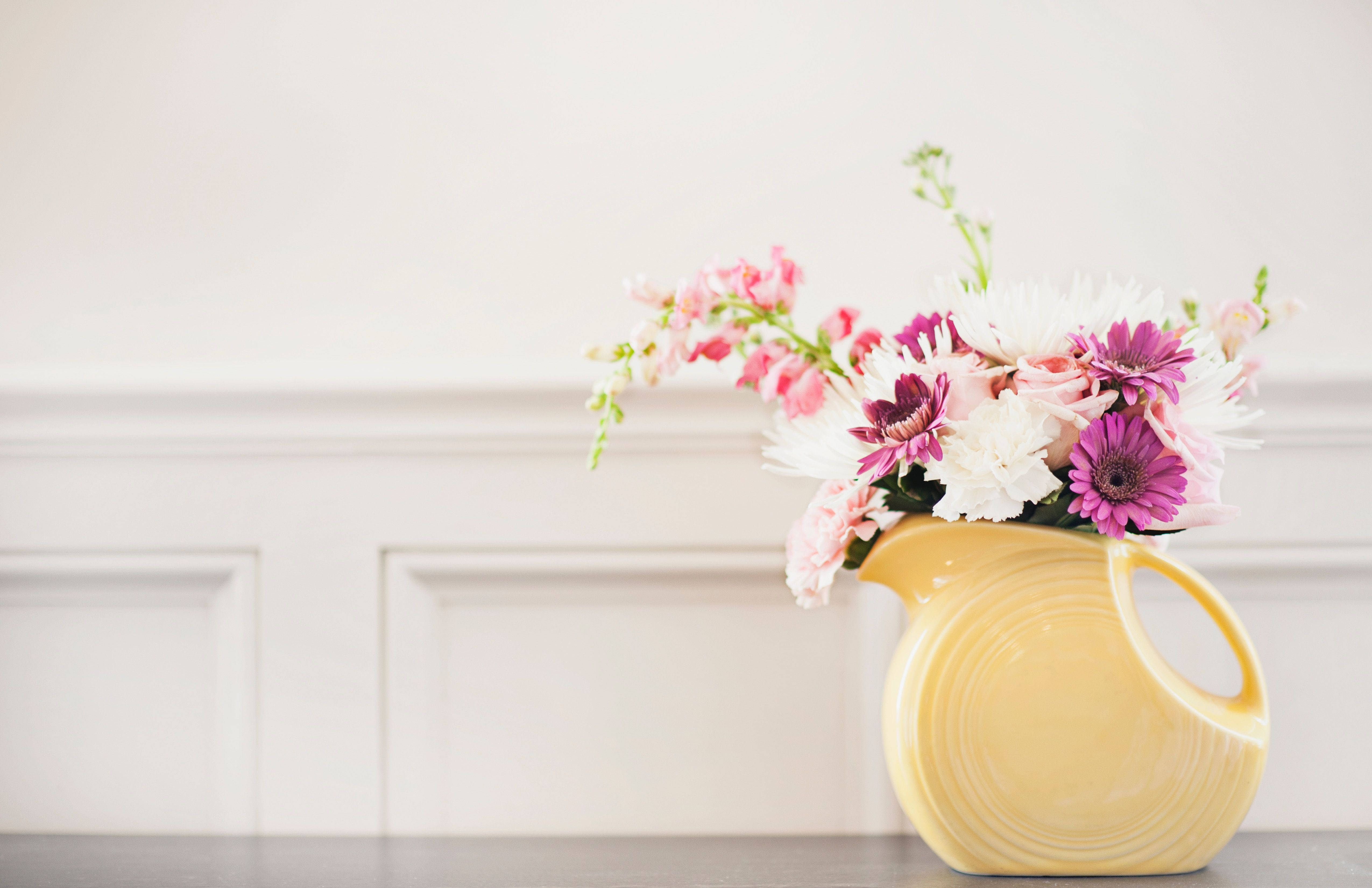 yellow ceramic pitcher, pink white and purple flowers, dark surface, 4K Desktop Wallpaper