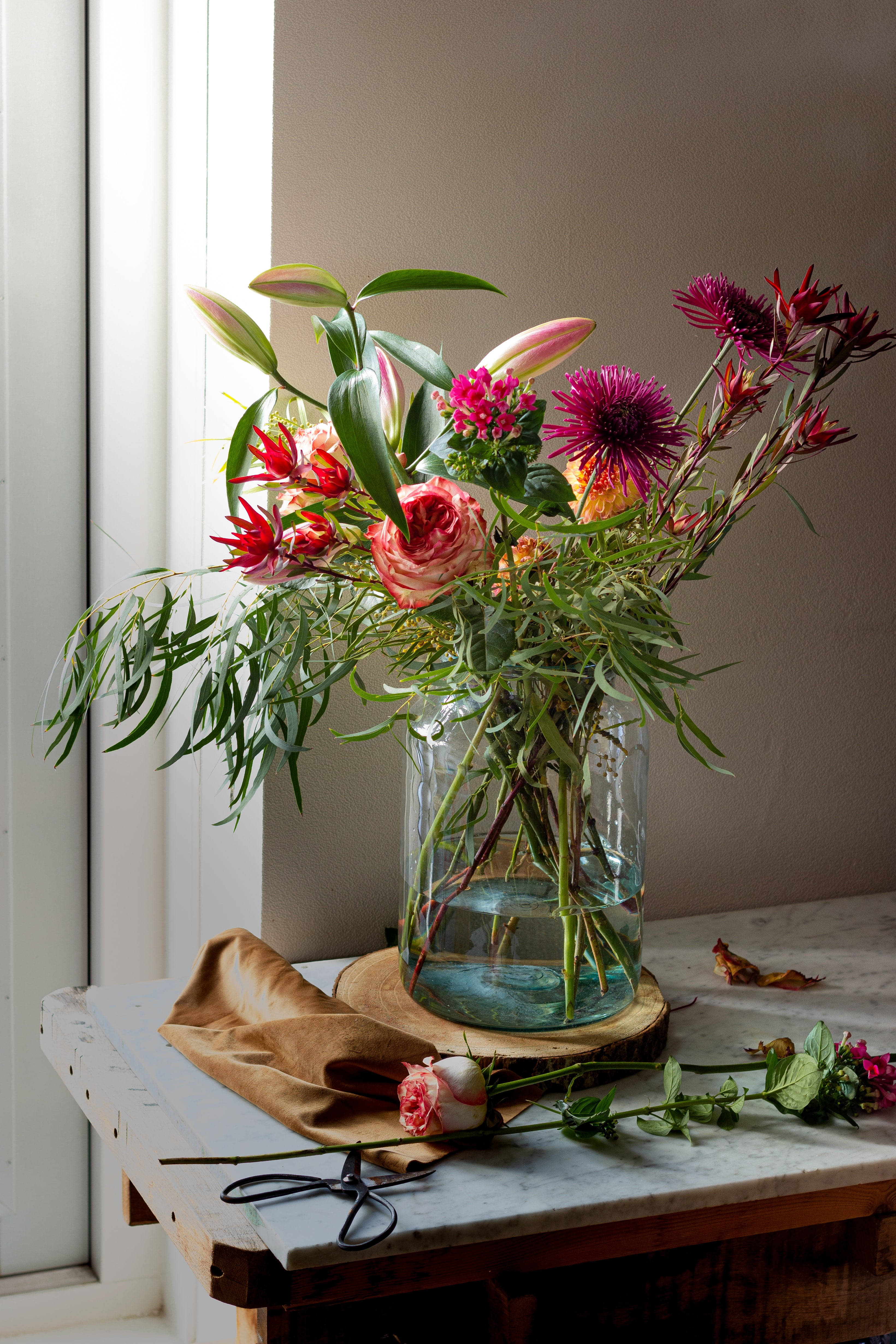 glass vase, marble-topped wooden table, bright window, 4K Phone Wallpaper