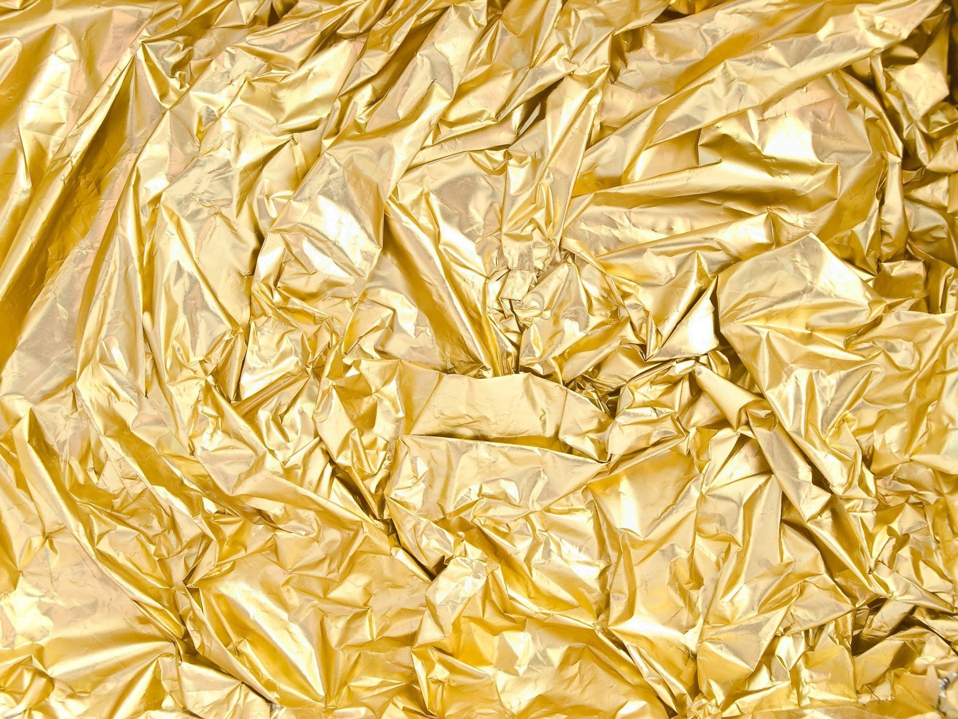 crumpled gold foil, shiny reflective folds, warm metallic highlights, Full HD Desktop Wallpaper
