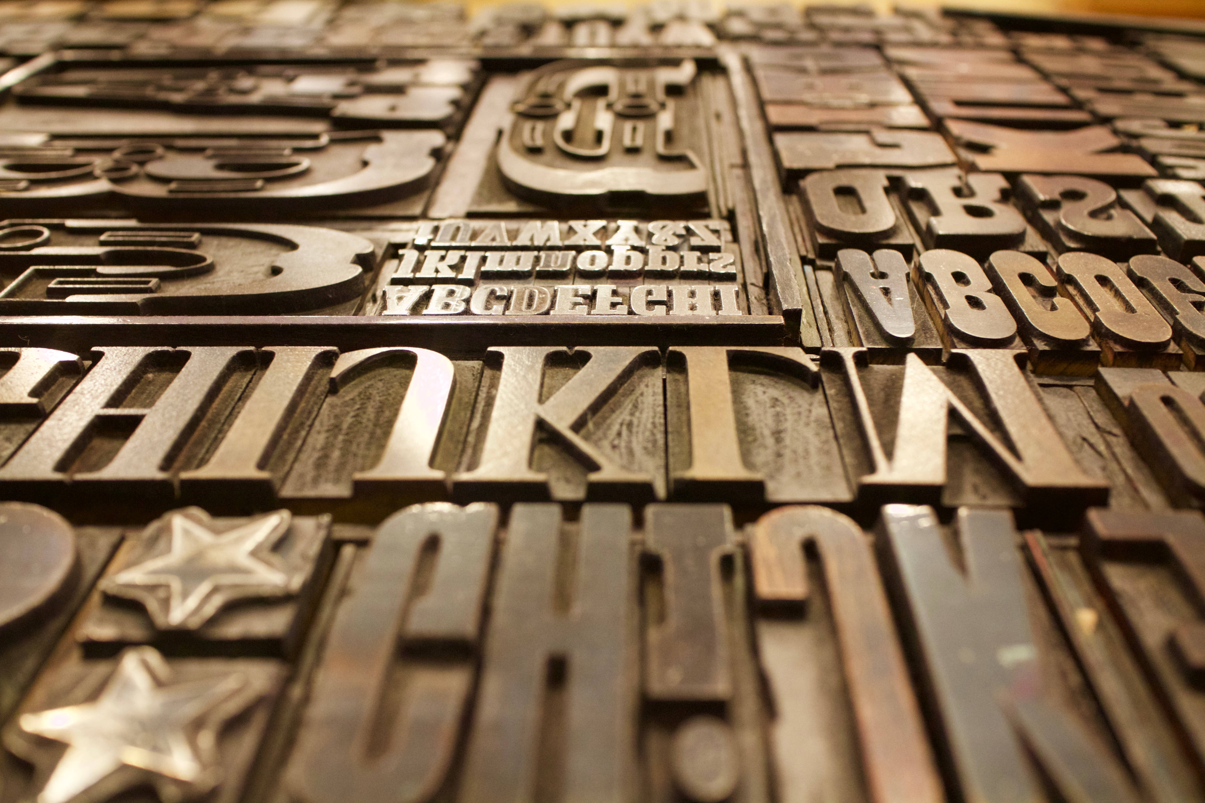 gold block font letters, vintage wooden letterpress type blocks, warm lighting, 5K Desktop Wallpaper