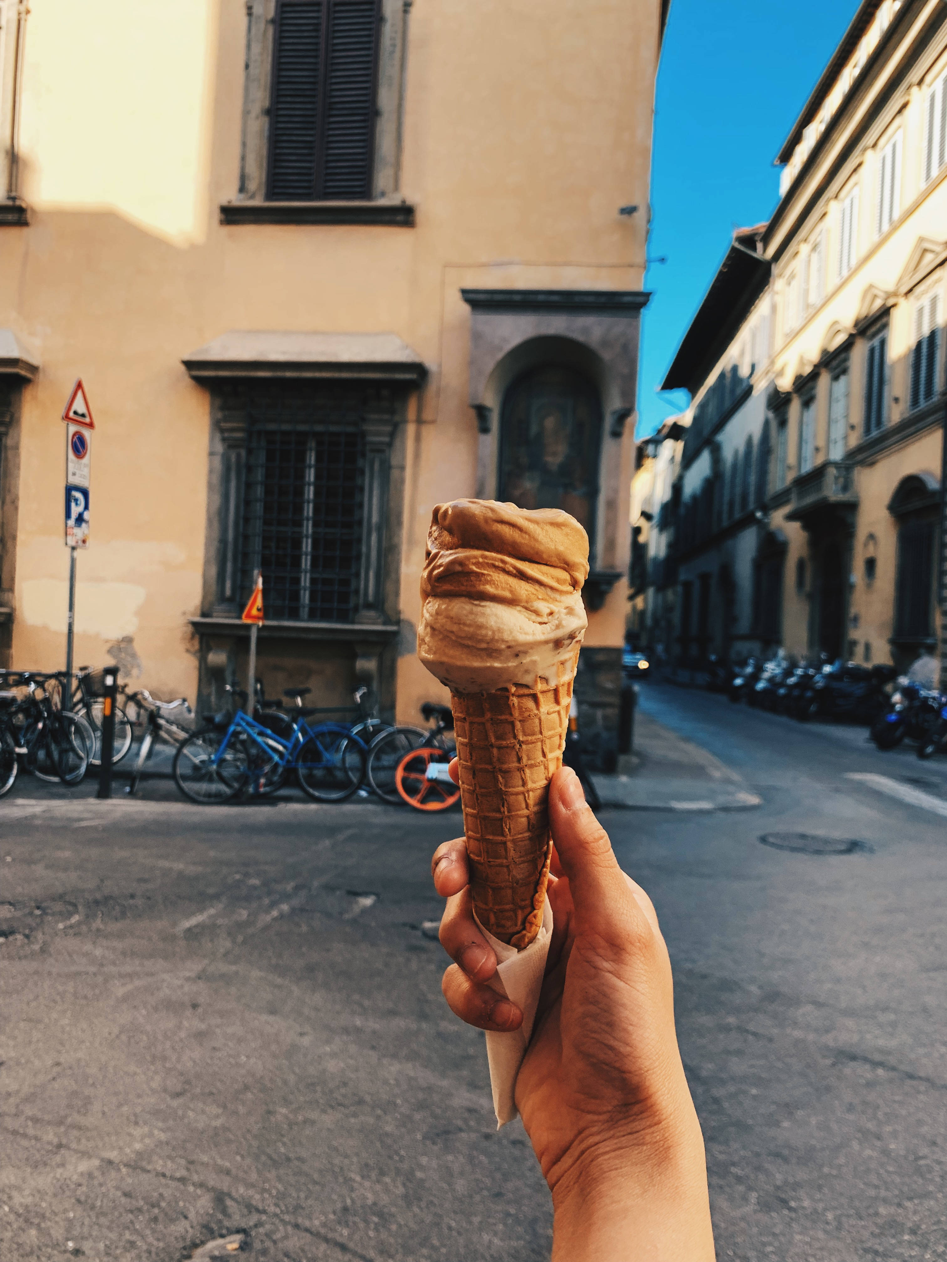 mocha ice cream, waffle cone, sunlit European street, 4K Phone Wallpaper