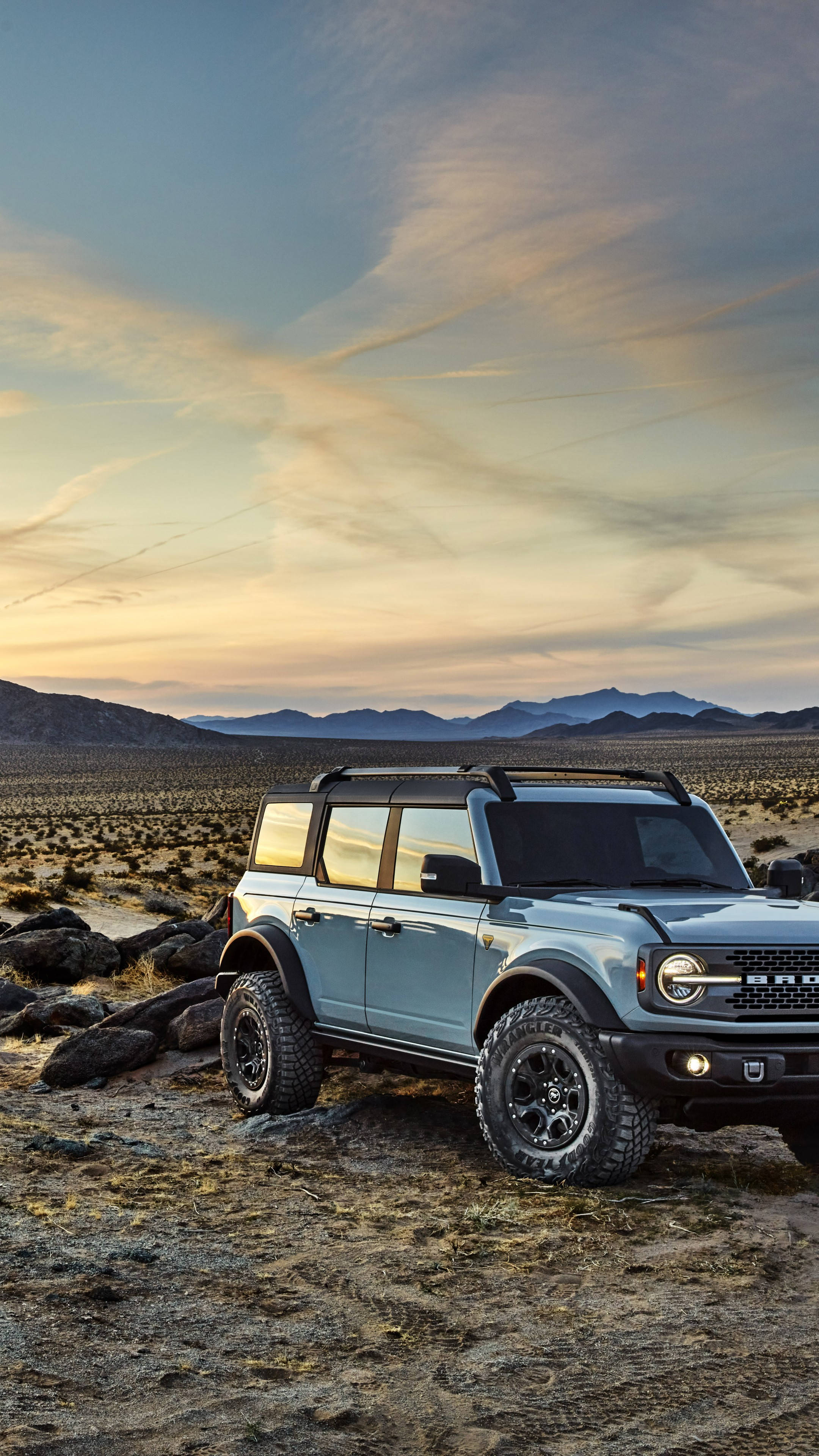 Ford Bronco, metallic blue paint, rocky desert terrain, 4K Phone Wallpaper