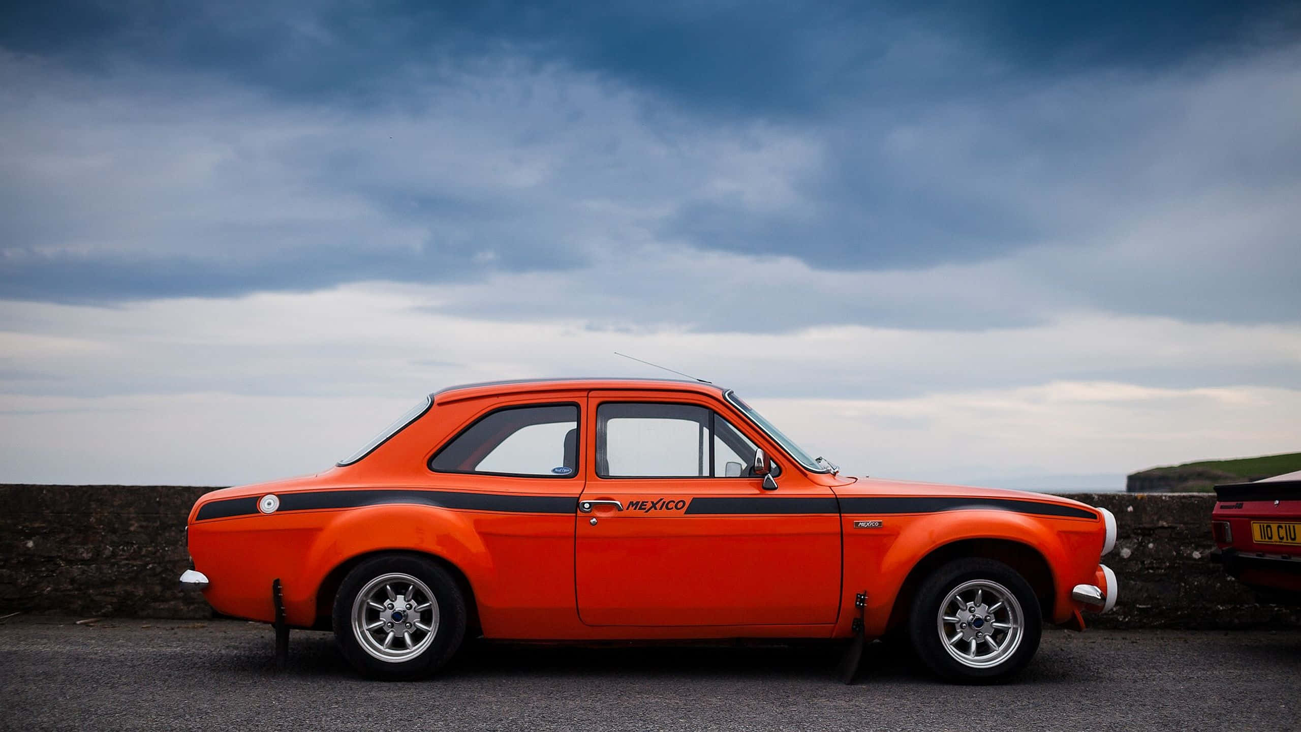 Ford Escort, vibrant orange, black racing stripes, 2K Desktop Wallpaper