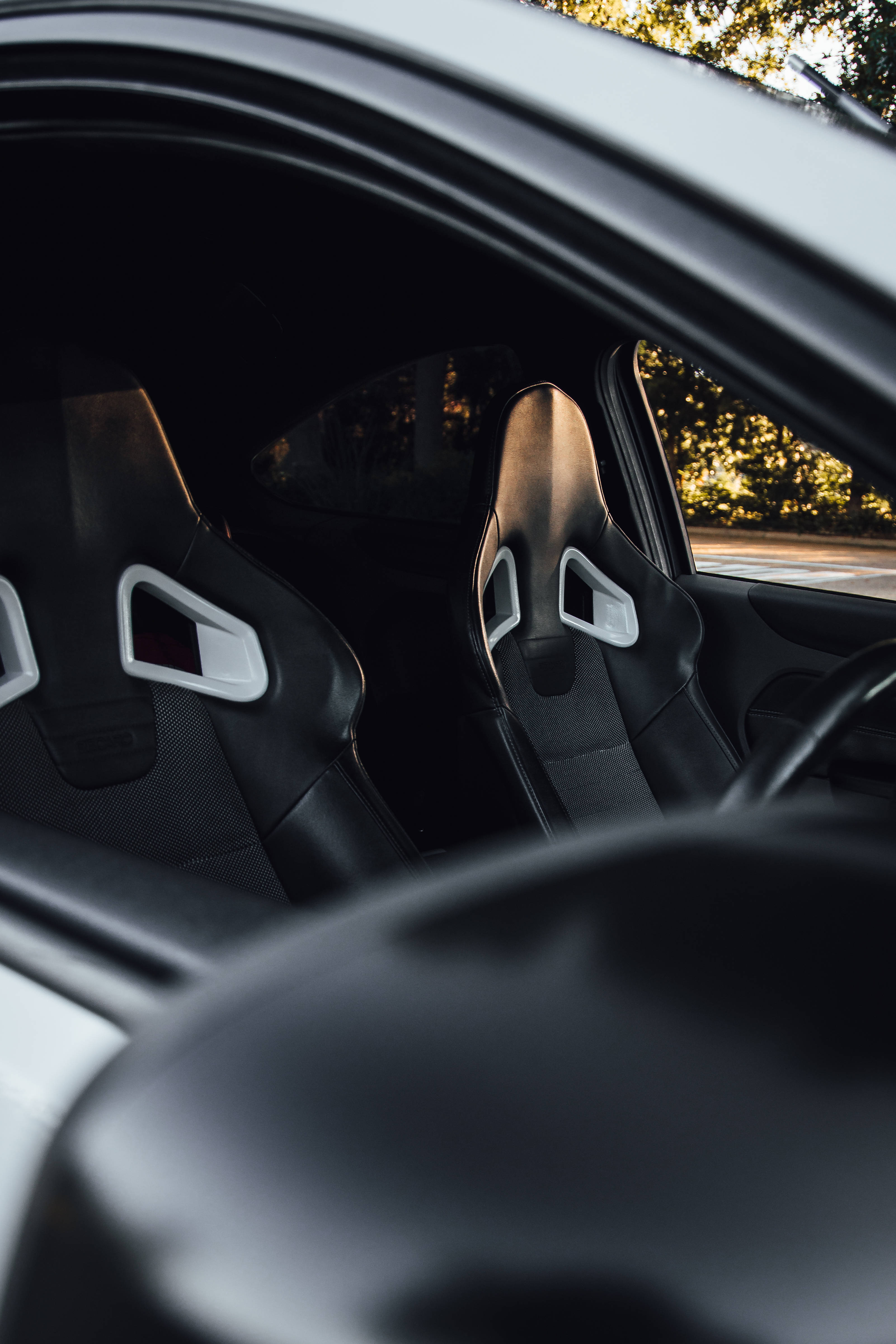 Ford iPhone, sleek sports car interior, black racing seats, 4K Phone Wallpaper