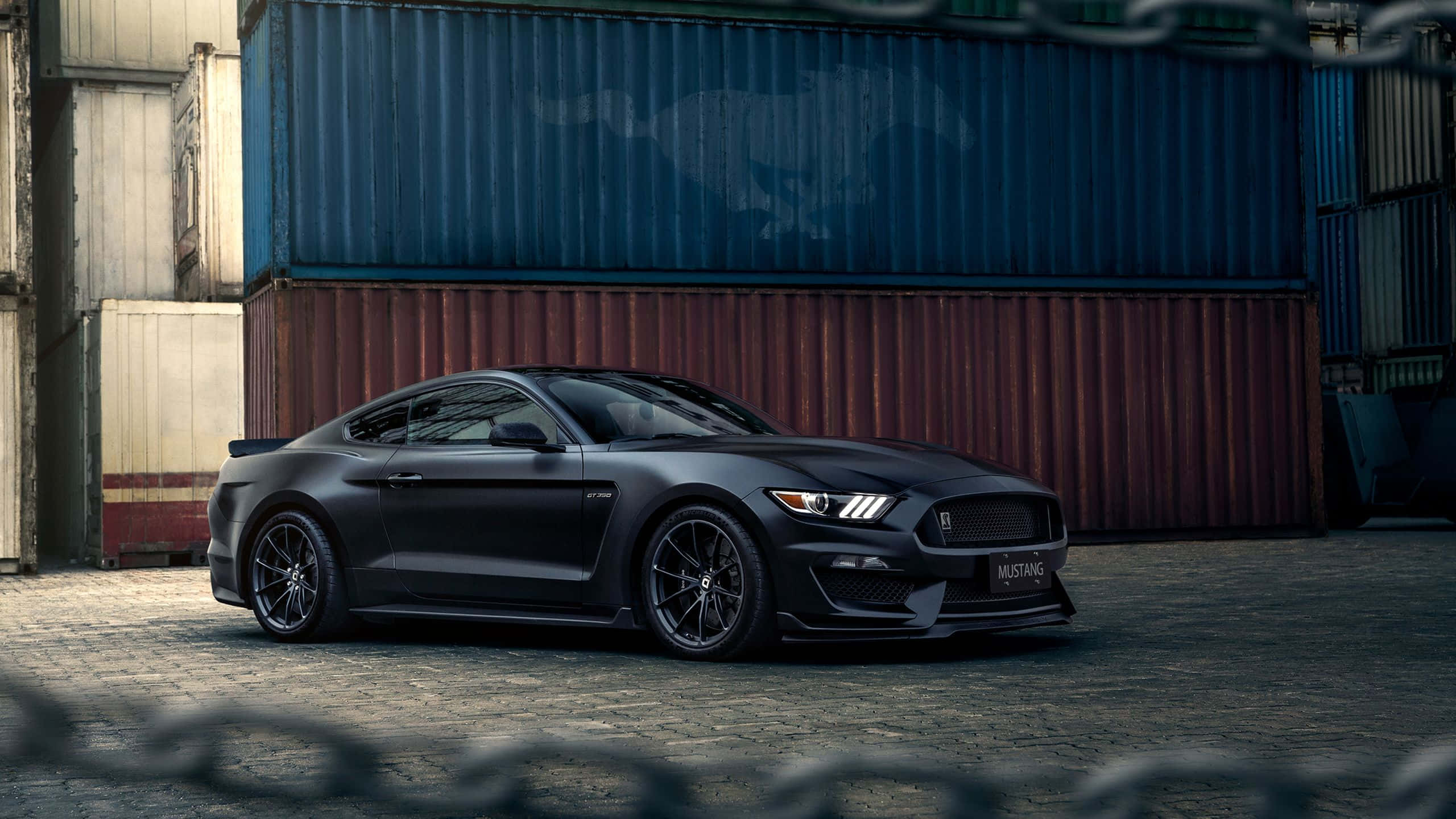 Ford Mustang Shelby GT350, matte black, stacked shipping containers, 2K Desktop Wallpaper