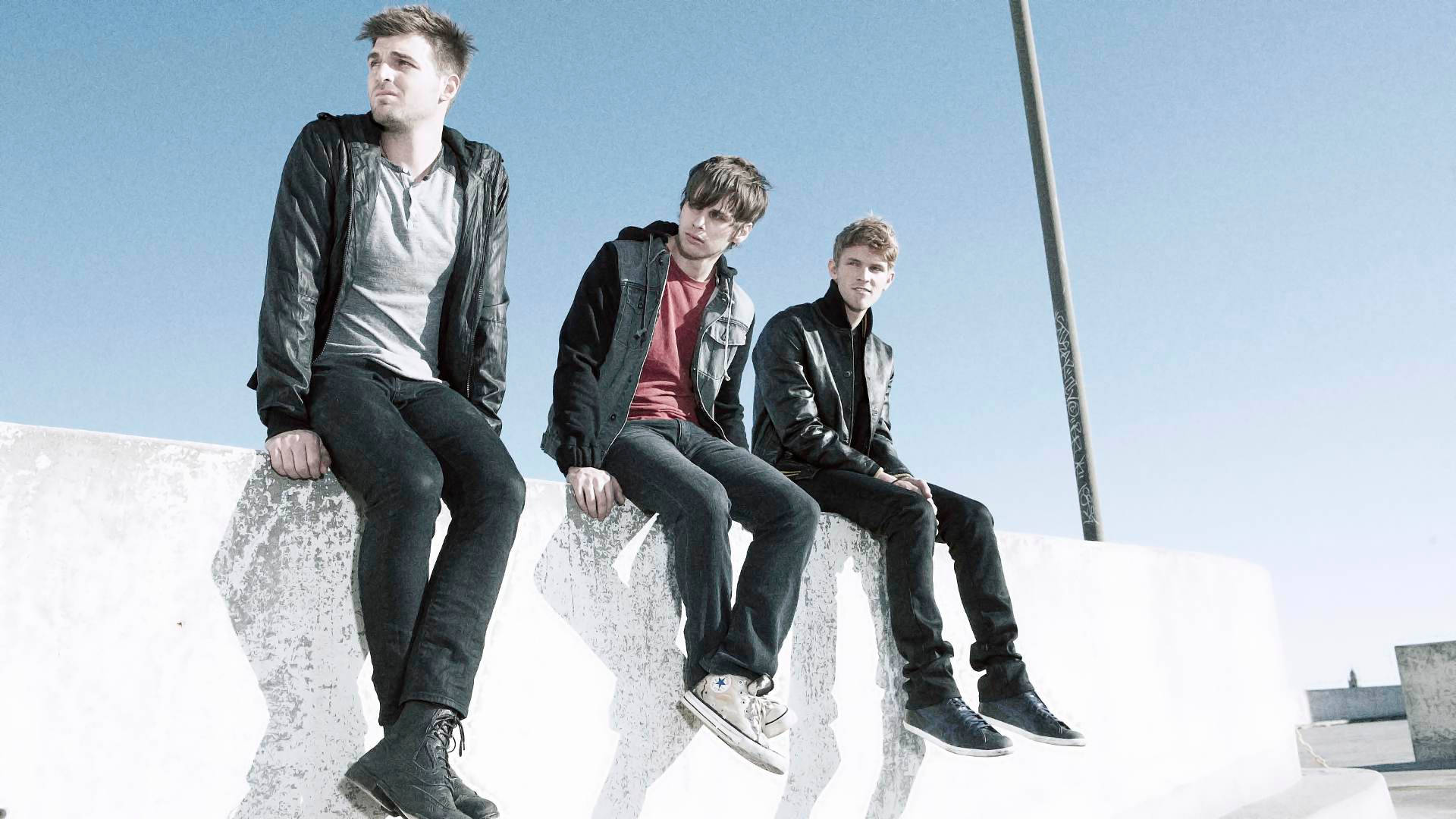 Foster the People, black jackets, sunlit concrete ledge, Full HD Desktop Wallpaper
