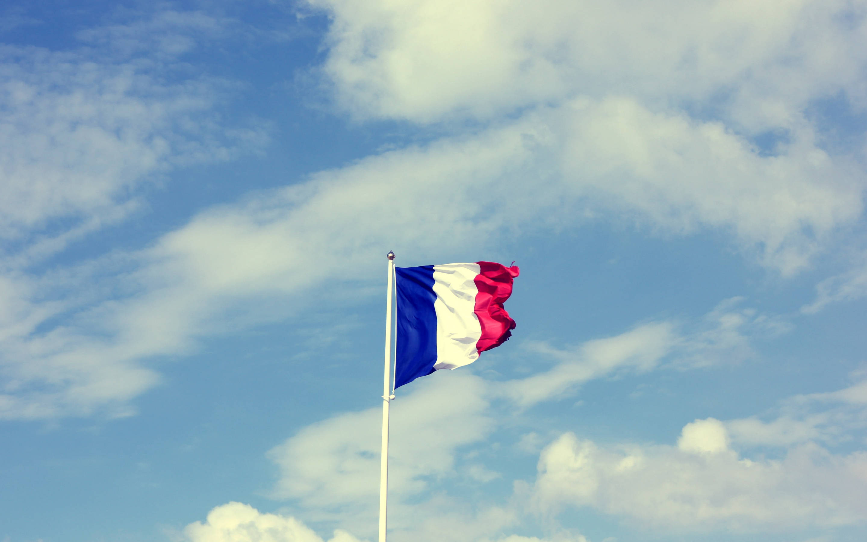 France flag, bright blue sky, fluffy white clouds, 2K Desktop Wallpaper