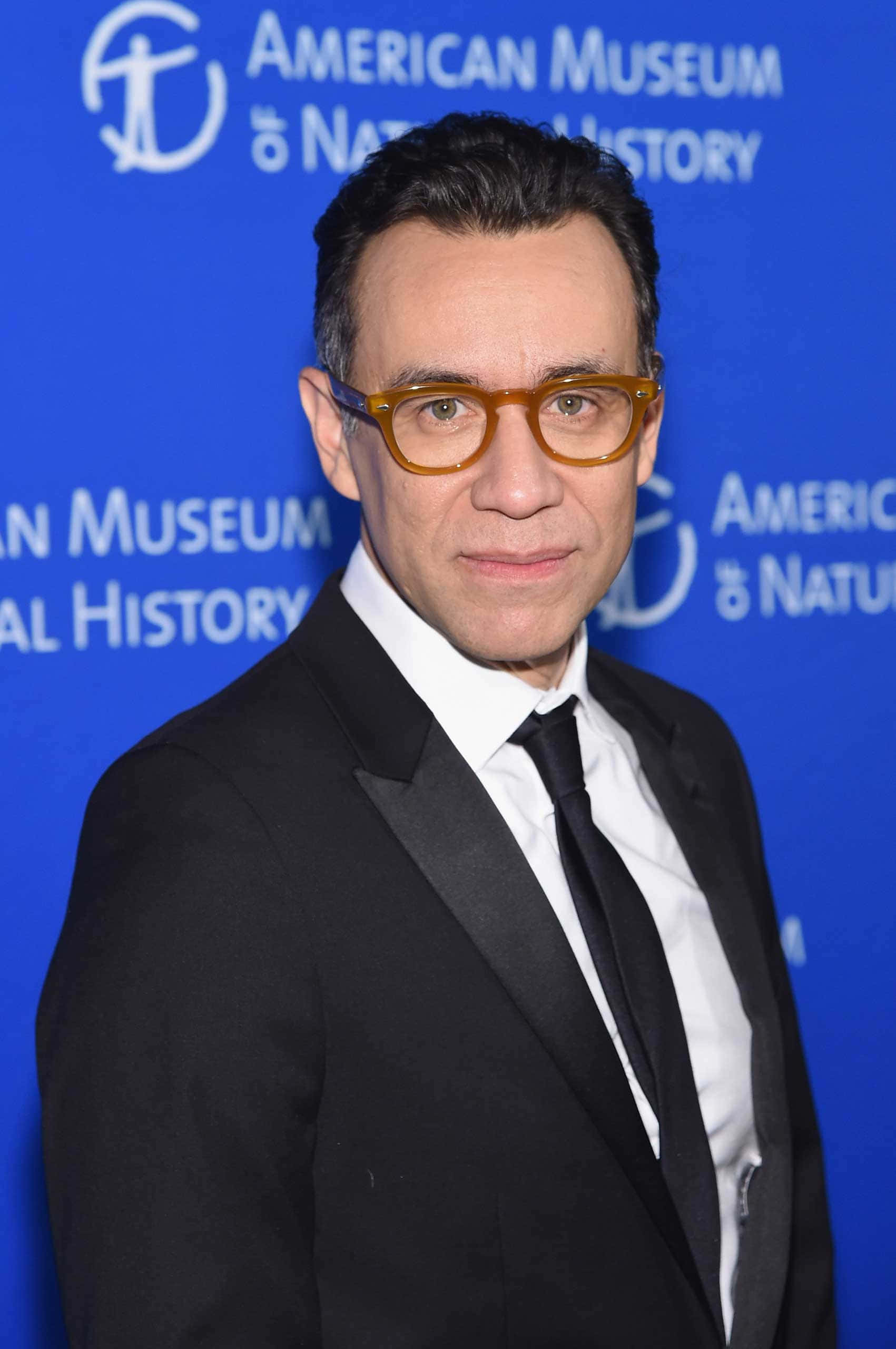 Fred Armisen, black suit, amber glasses, 2K Phone Wallpaper