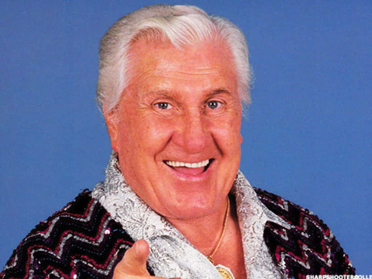 Freddie Blassie, sequined zigzag jacket, solid blue background, SD Desktop Wallpaper