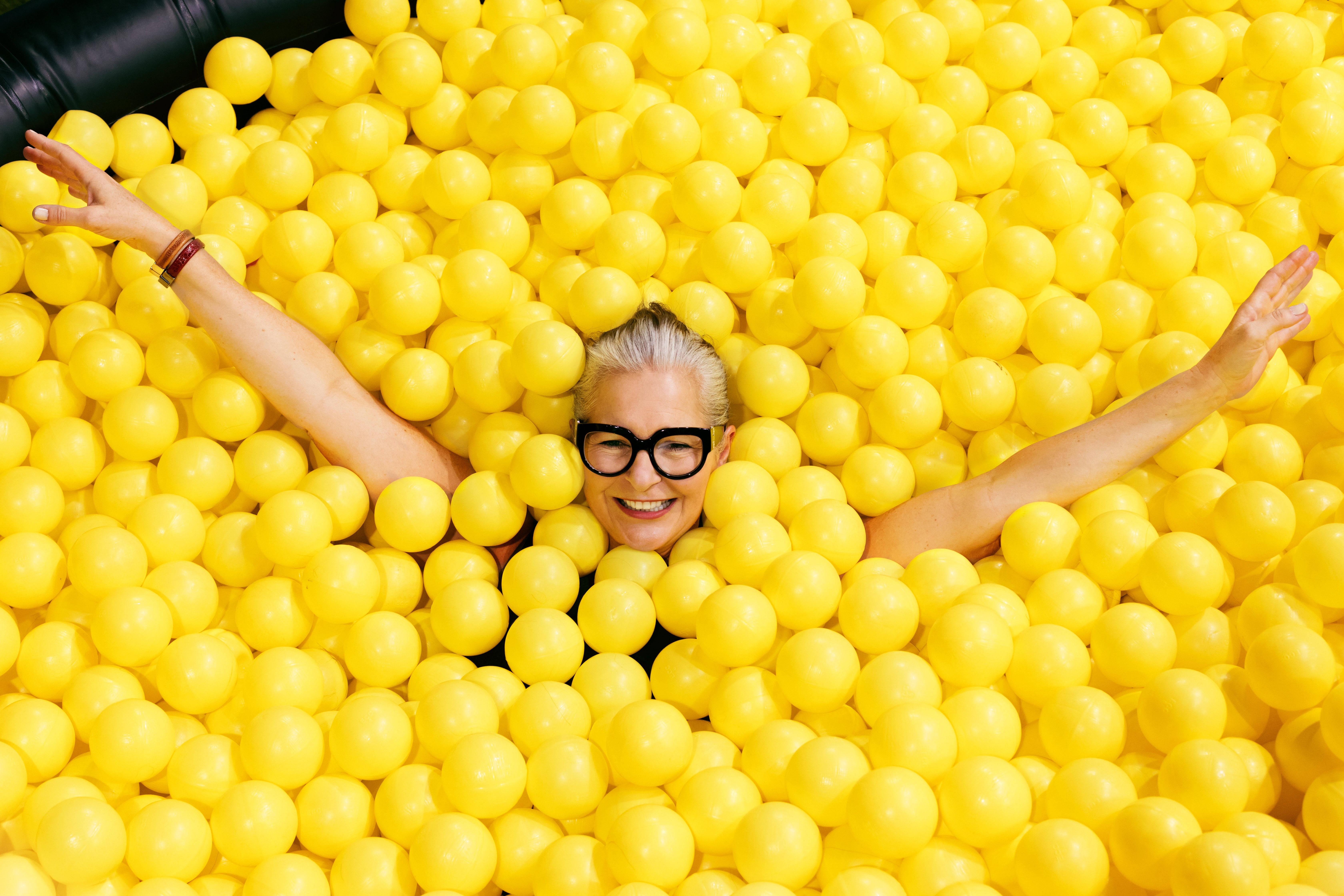woman, yellow plastic balls, glasses, 5K Desktop Wallpaper