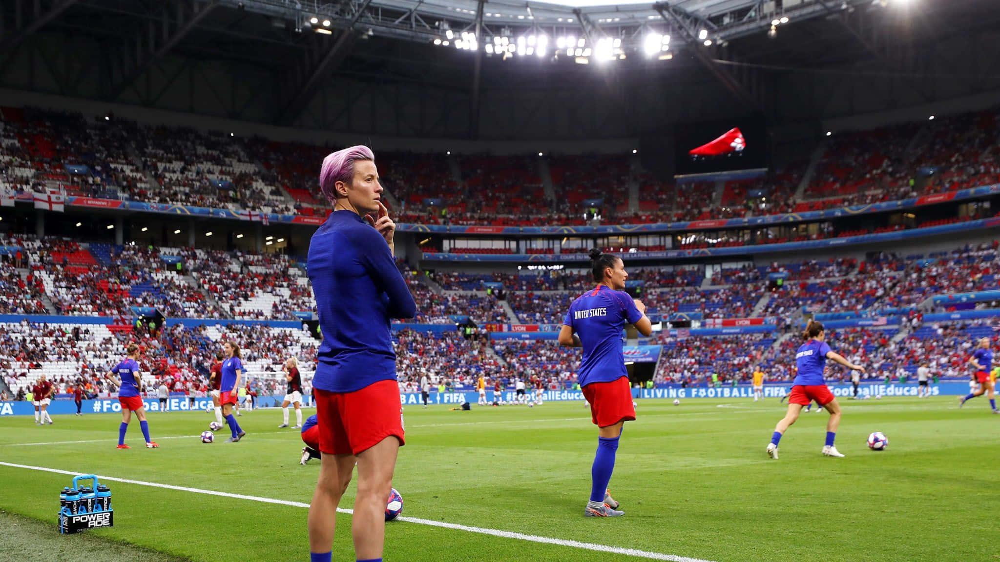 female soccer player, blue and red warm up, vibrant green field, Full HD Desktop Wallpaper