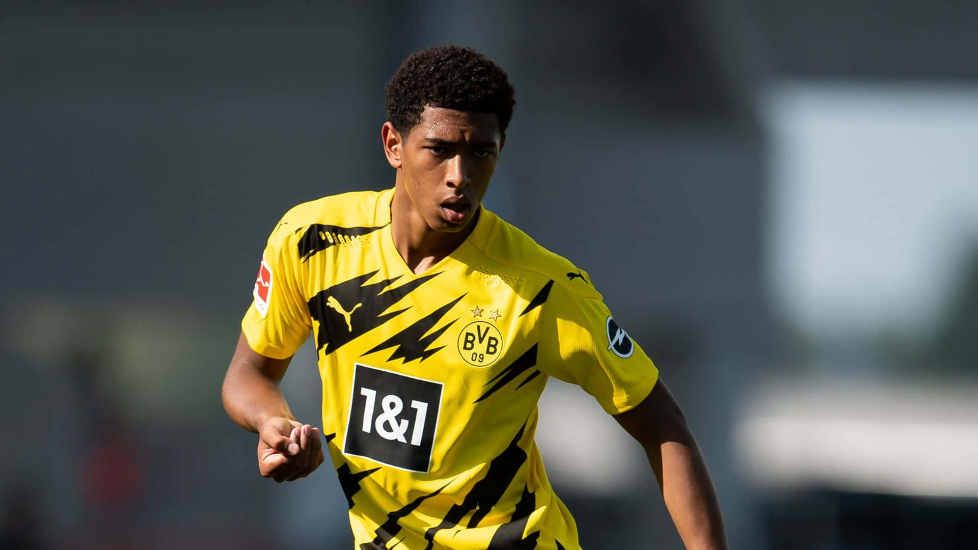 soccer player, vibrant yellow and black jersey, daytime match, Full HD Desktop Wallpaper