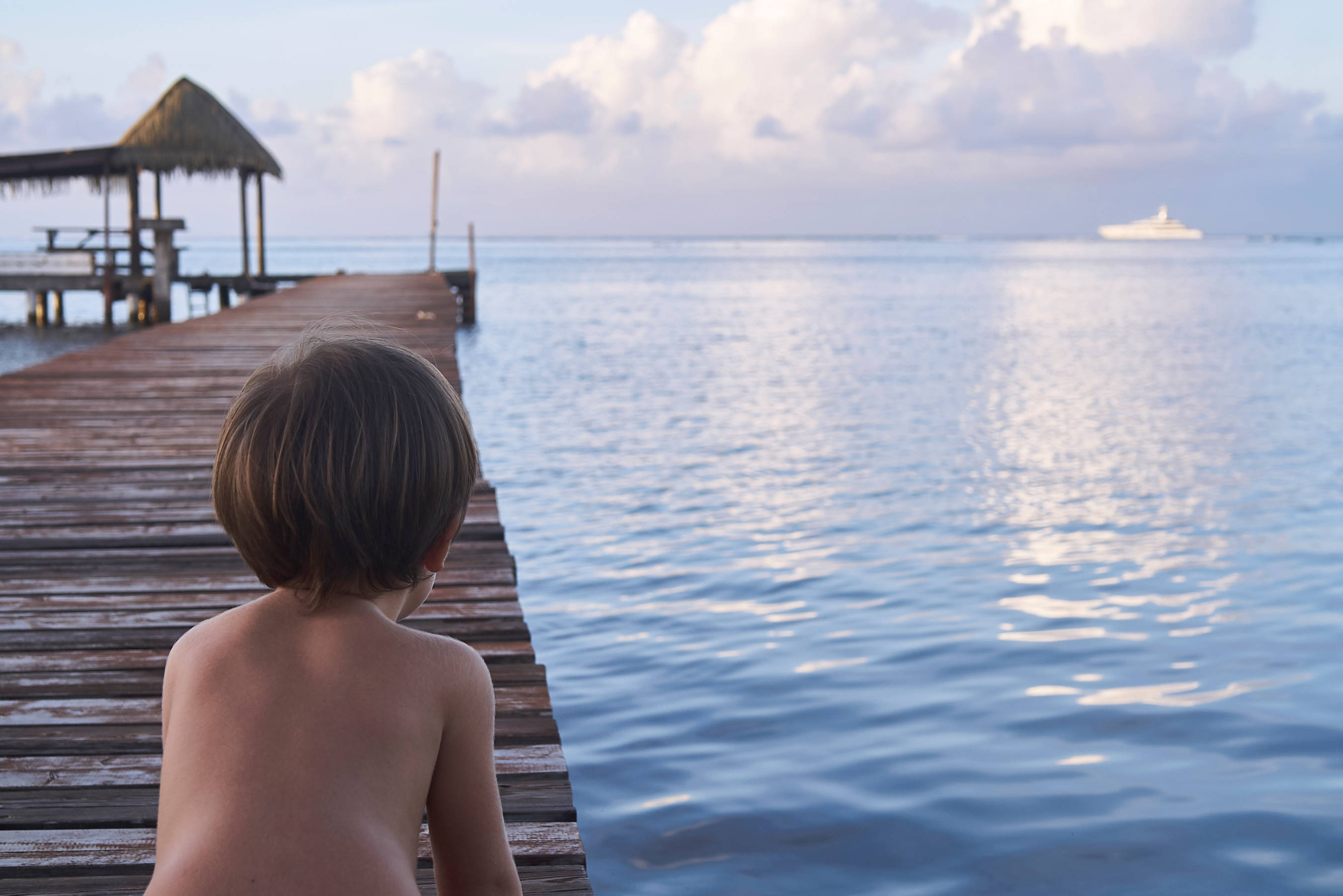young boy, French Polynesia, wooden pier, 2K Desktop Wallpaper
