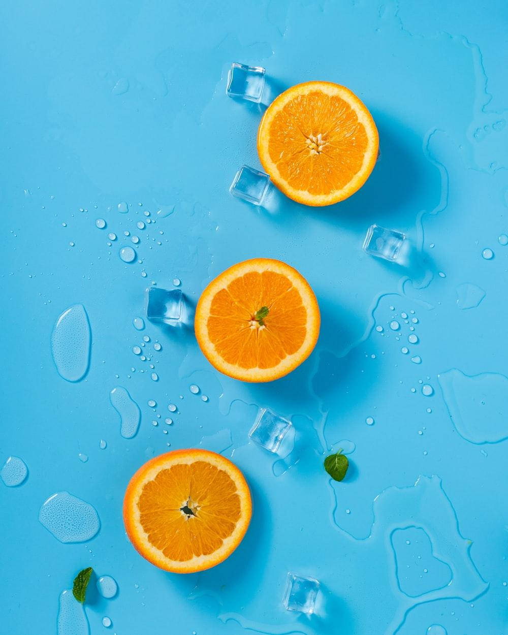 pastel orange, bright blue surface, water droplets, SD Phone Wallpaper