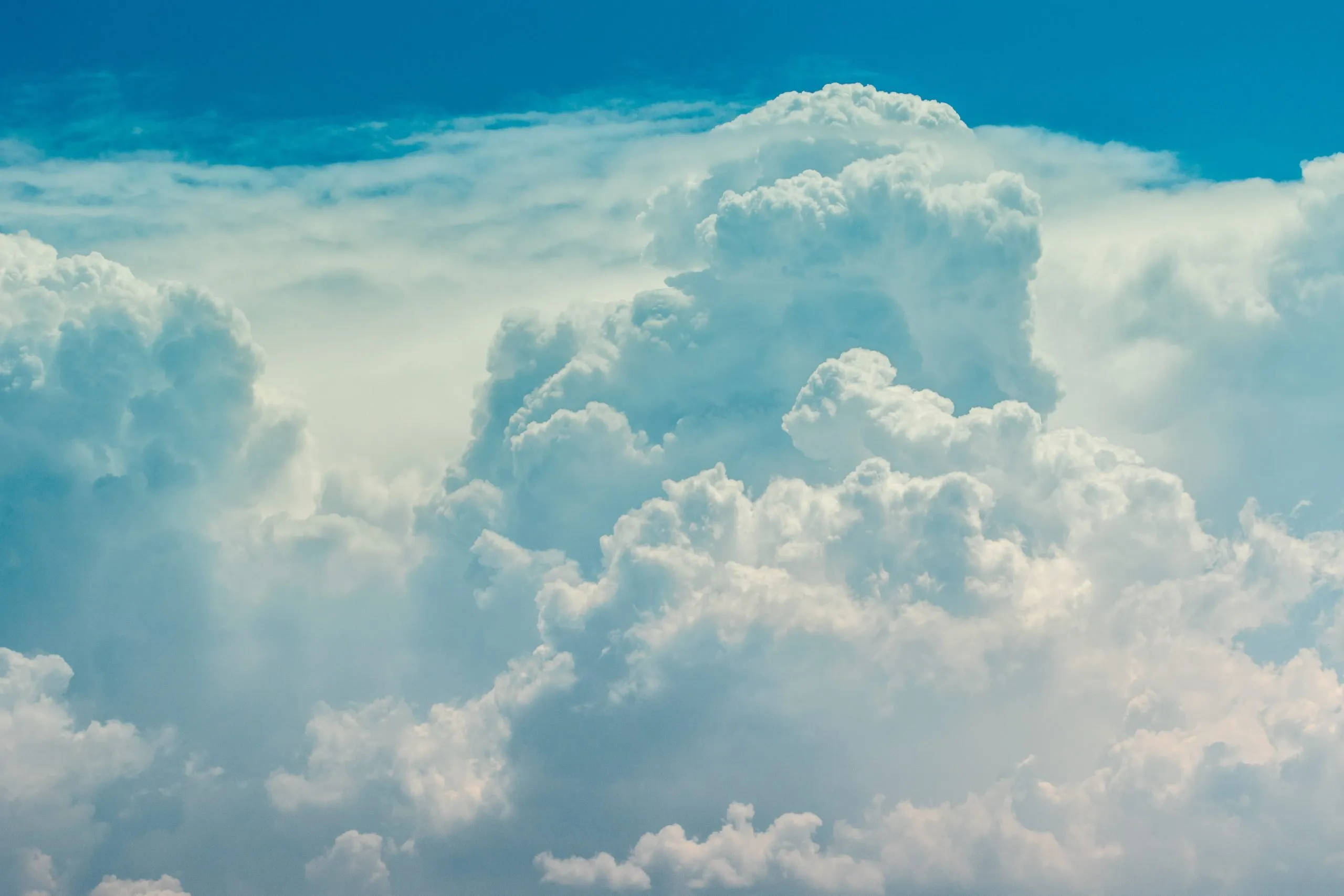 Funeral Clouds, vast fluffy white clouds, vibrant blue sky, 2K Desktop Wallpaper