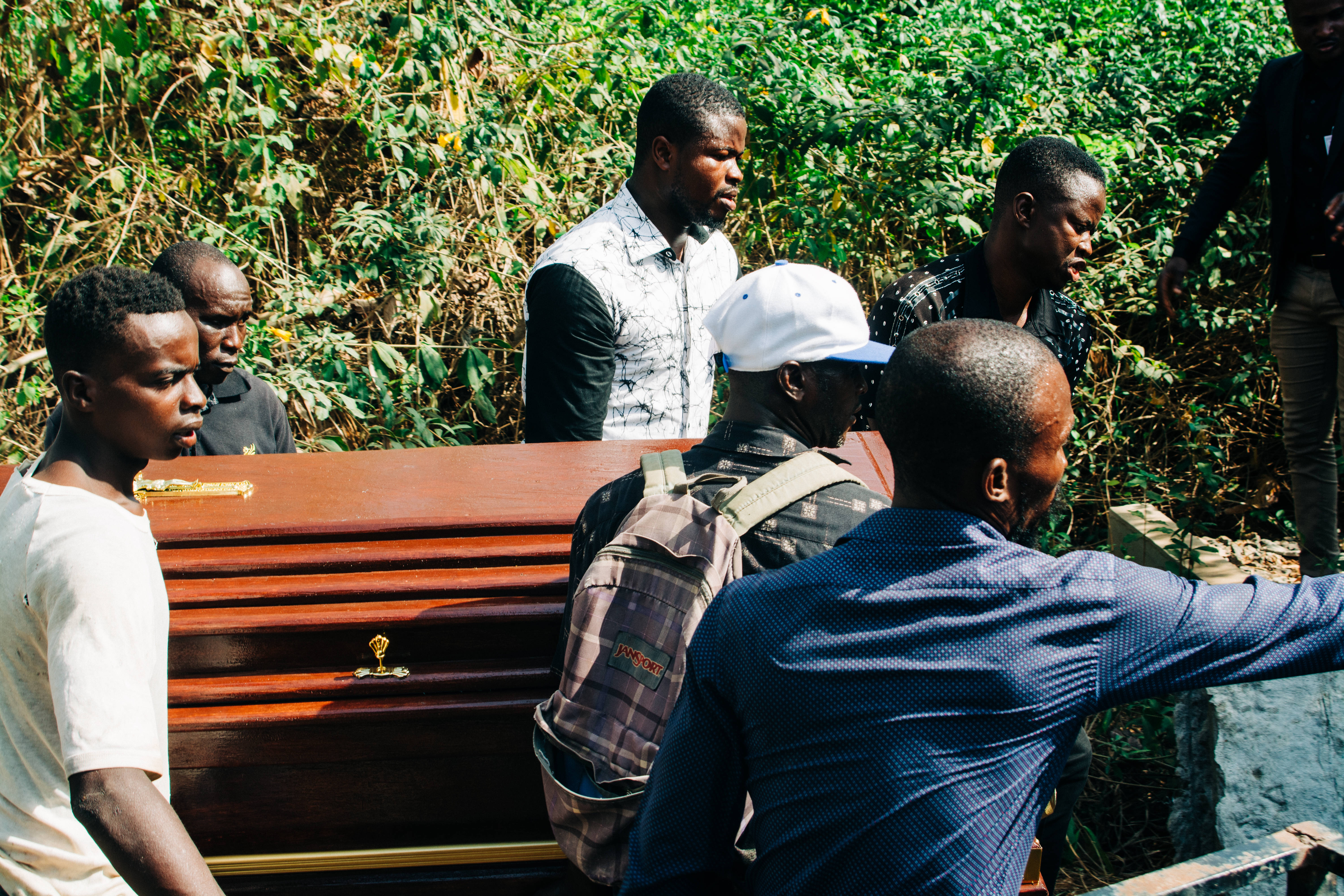 rural funeral, polished wooden coffin, lush green foliage, 5K Desktop Wallpaper