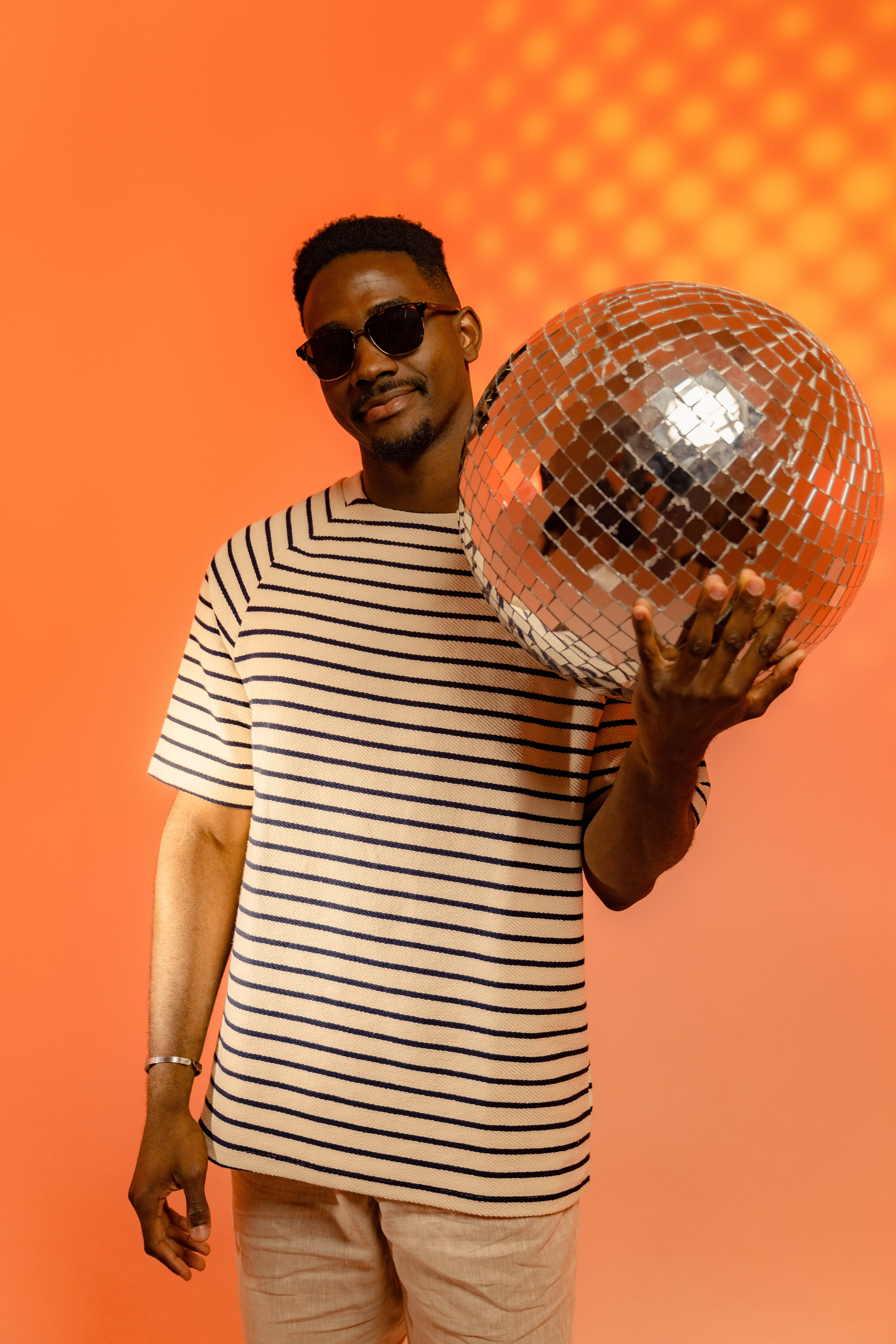 Funky Black Man, glittering disco ball, striped shirt, 5K Phone Wallpaper