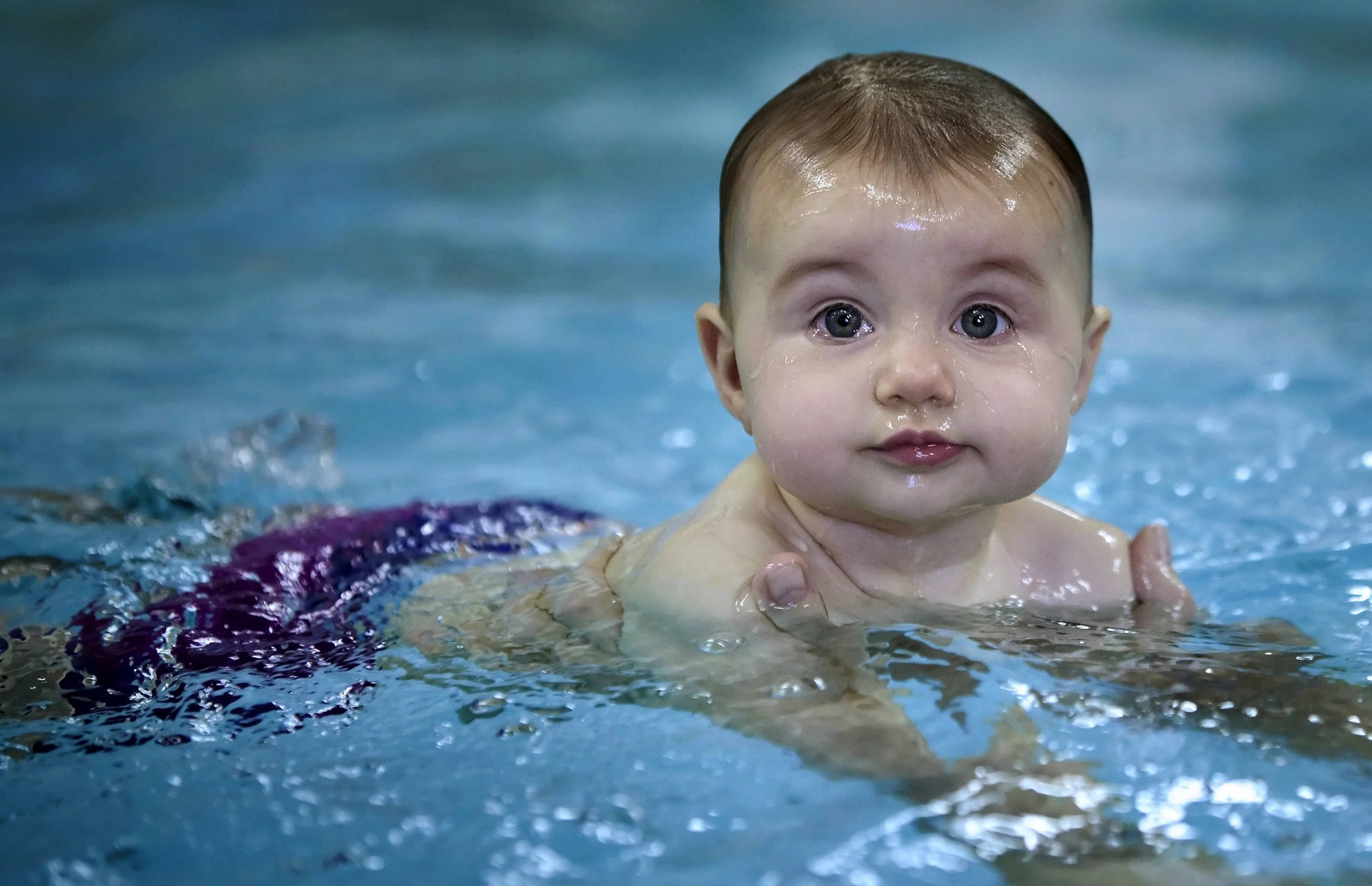 Funny Baby, wide curious eyes, clear blue water, 2K Desktop Wallpaper