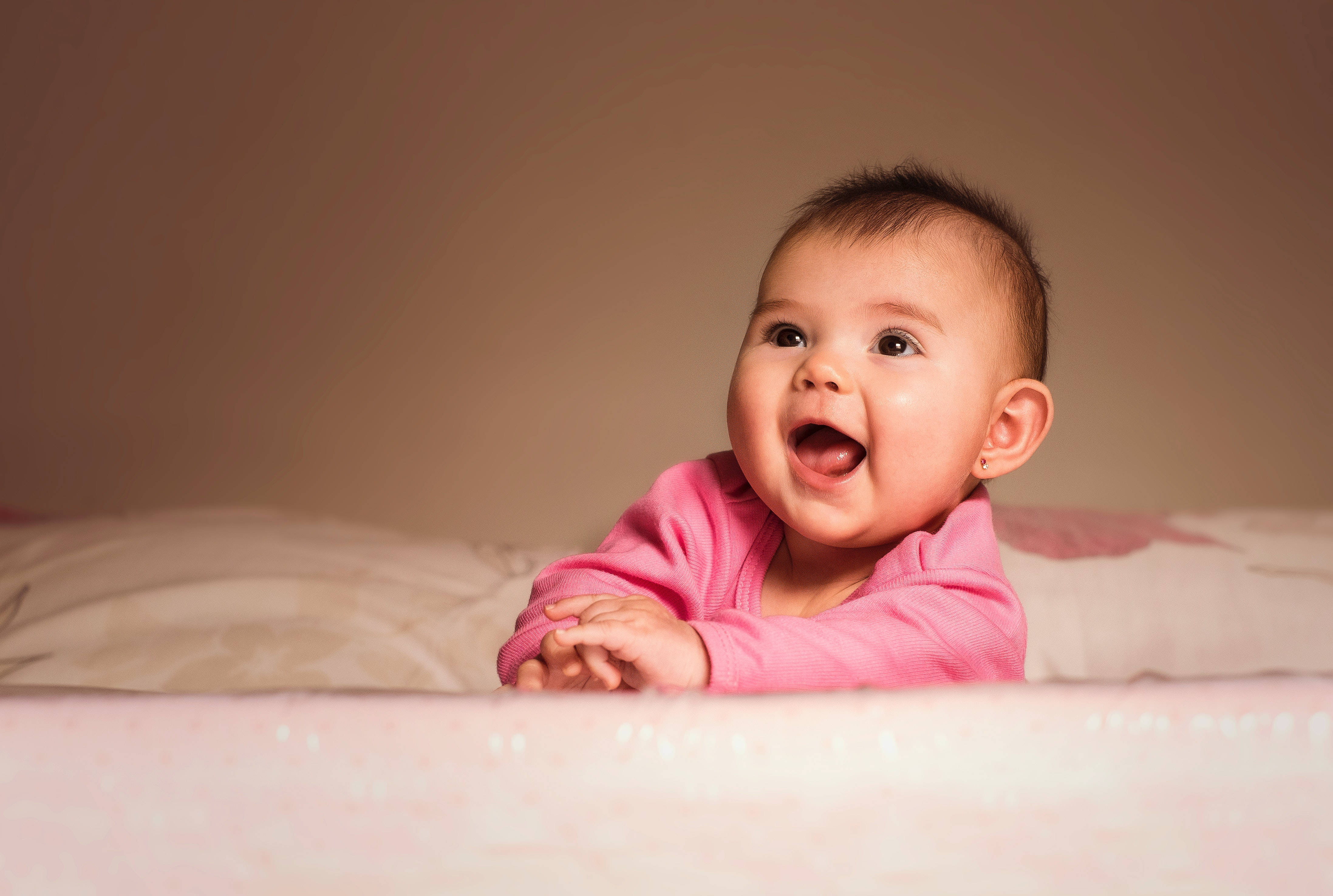 pink onesie, soft bed, warm lighting, 4K Desktop Wallpaper