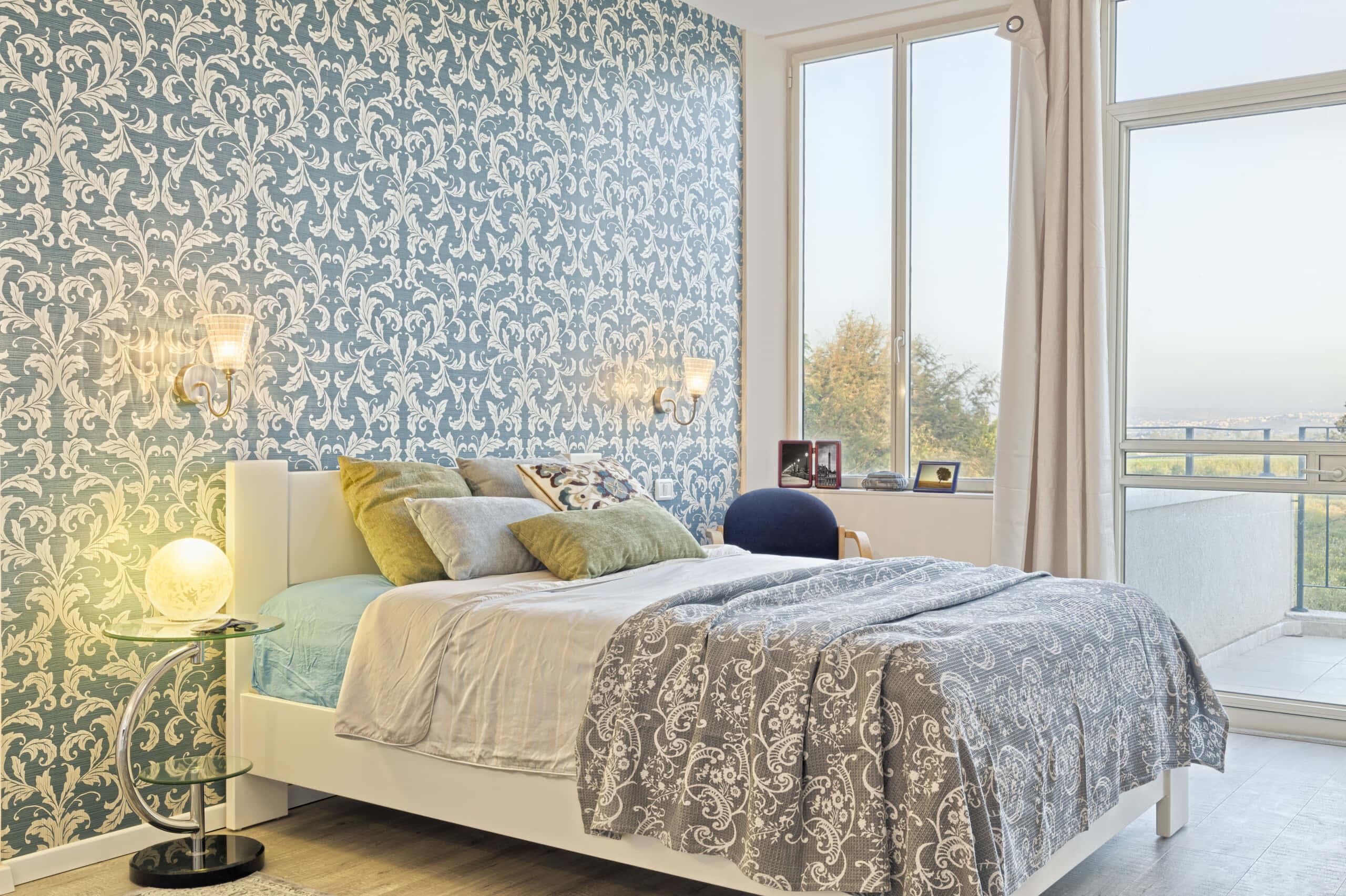 modern contemporary style bed, blue damask wallpaper, matching patterned linens, 2K Desktop Wallpaper
